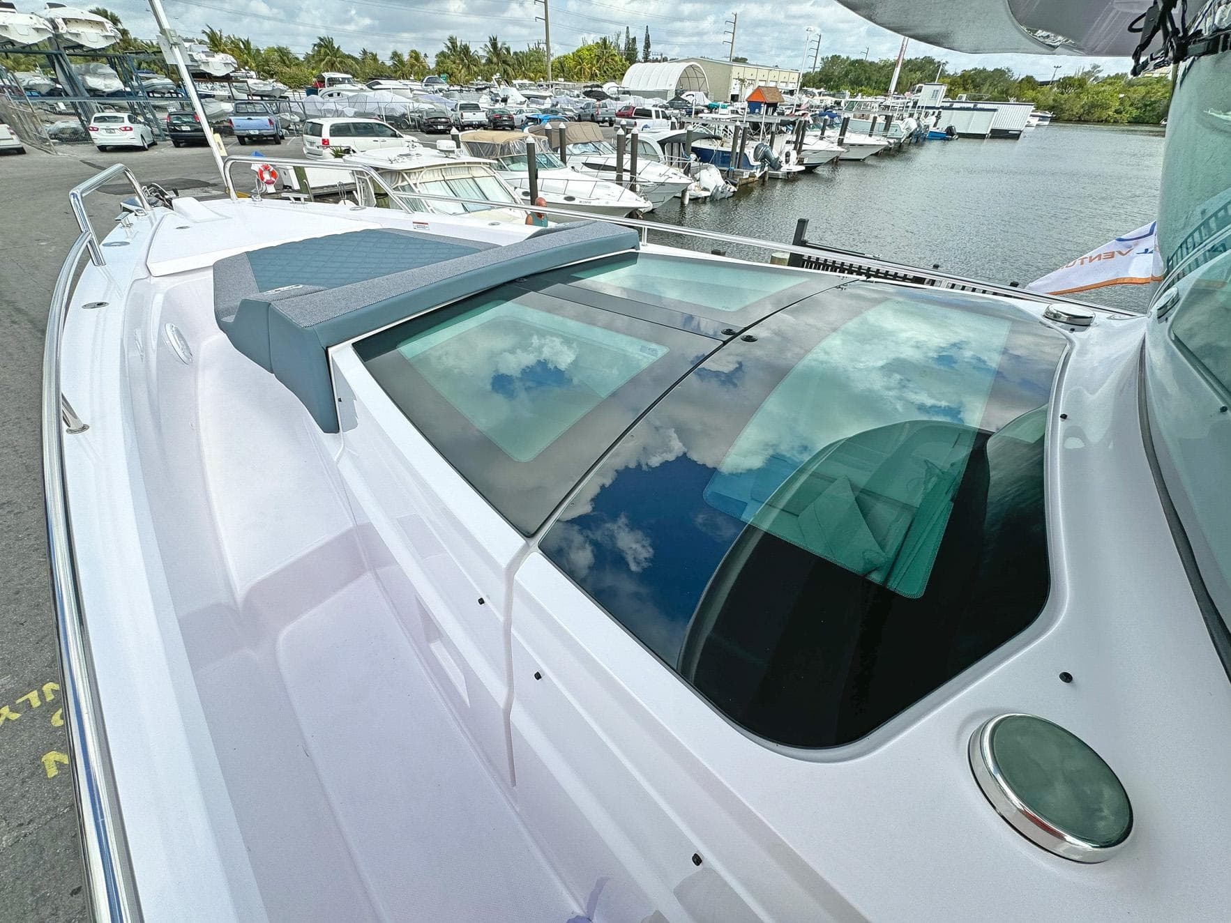 2024 Axopar 37XC CROSS CABIN boat docked at marina, showcasing sleek design and spacious cabin.