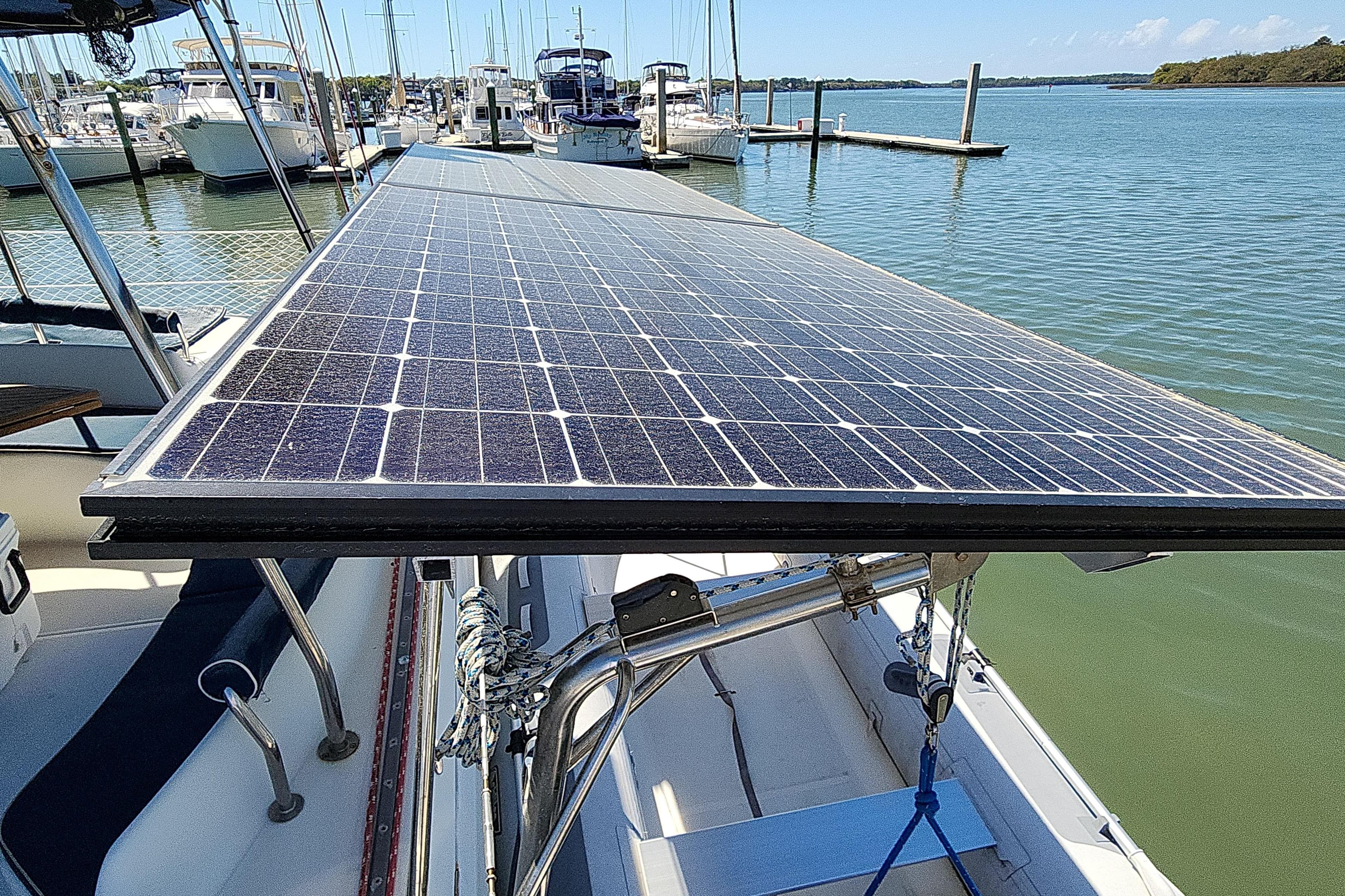 Solar panels on a 2001 Privilege 435 catamaran docked at a marina.