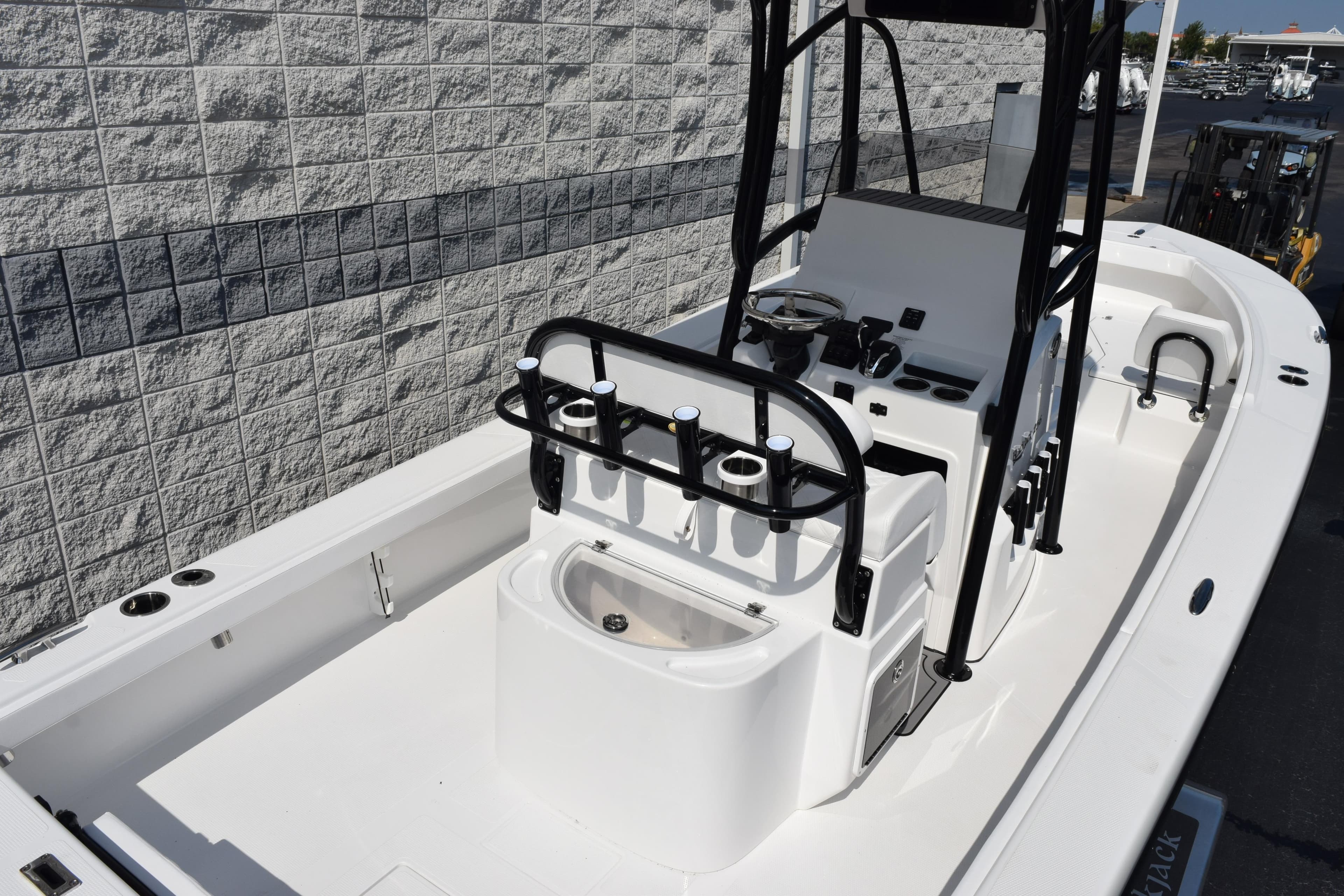 2026 BlackJack 256 Coastal boat interior with steering console and rod holders.