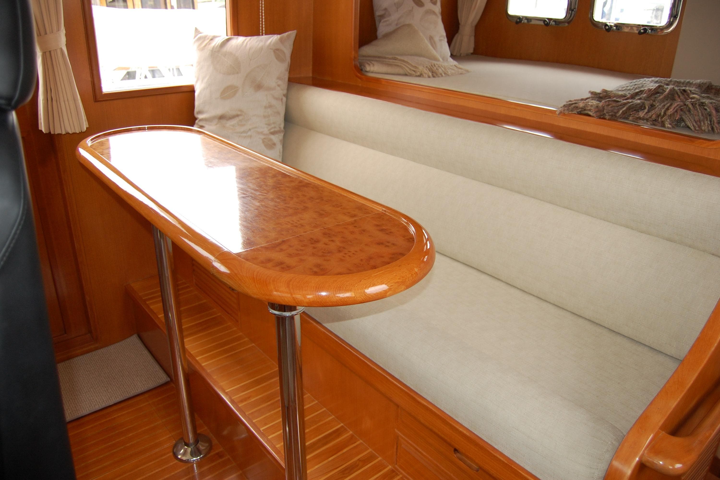 Luxurious interior of 2001 Ocean Alexander Classico yacht with elegant wood and plush seating.