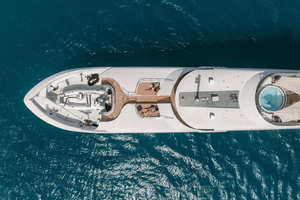 Aerial view of 2012 Ares Custom Marine Custom 141 yacht on blue ocean water.