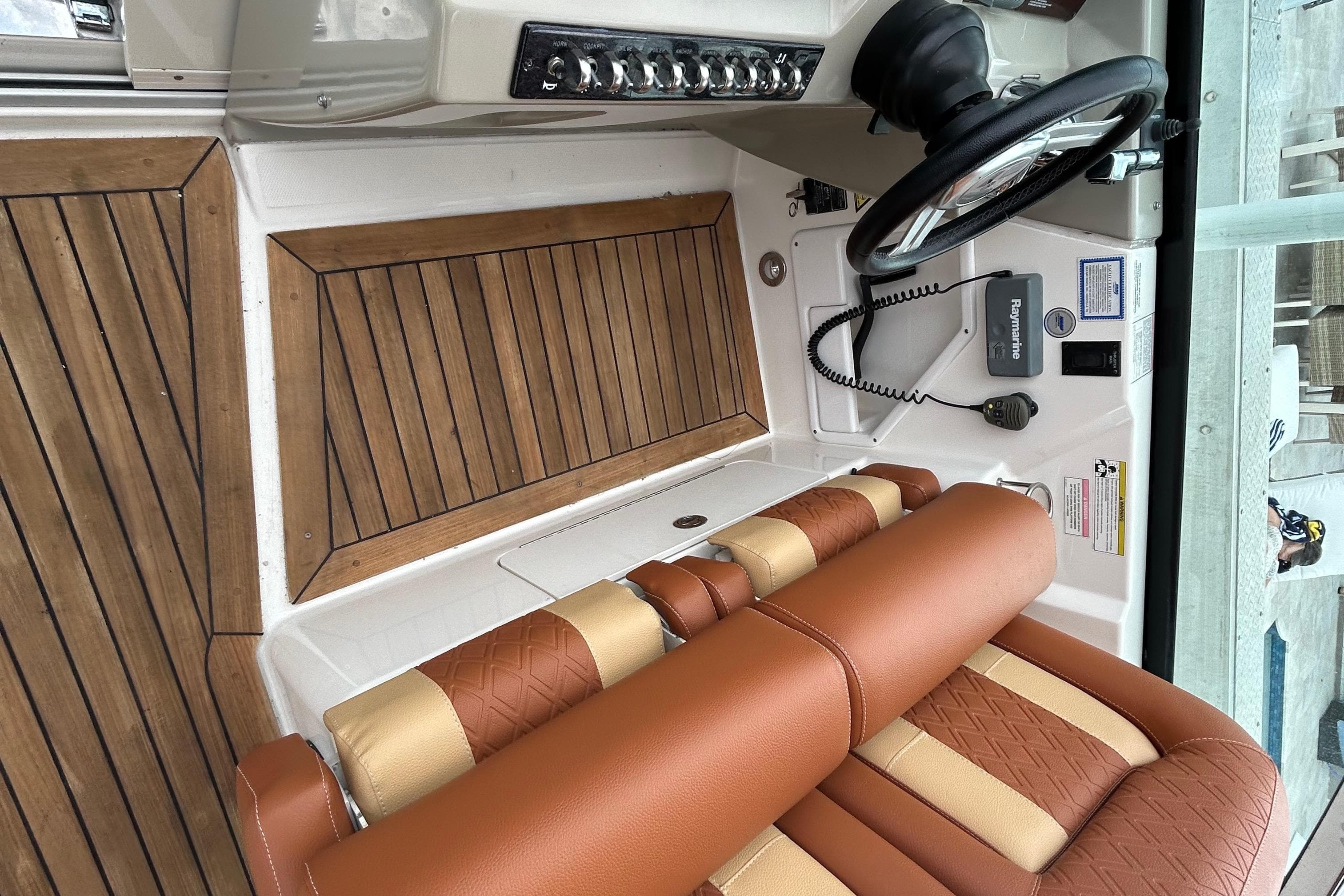 2014 Sea Ray 370 Venture helm with wood accents and leather seating.