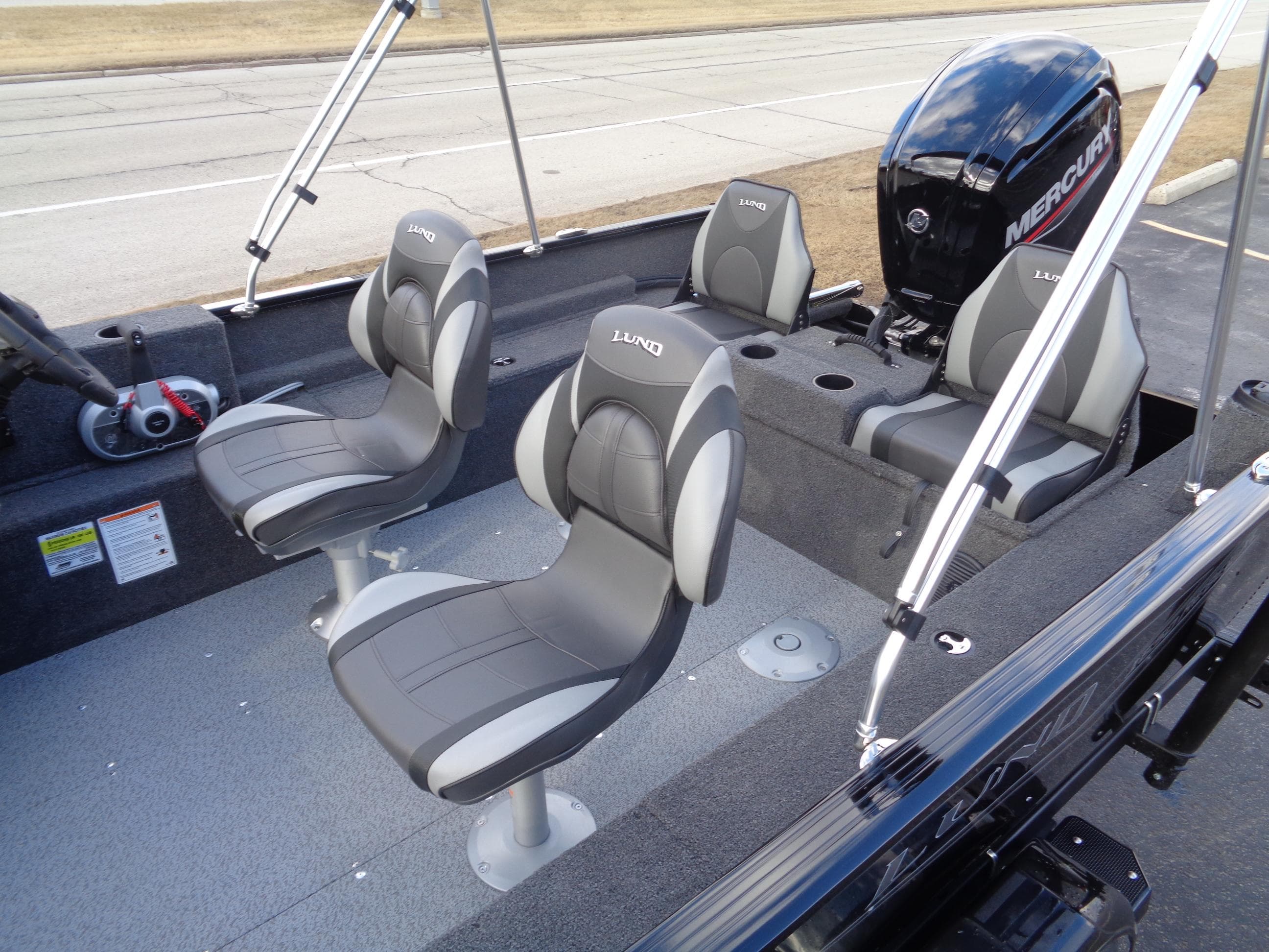 2025 Lund 1650 Rebel XL SS boat interior with seating and Mercury outboard motor.