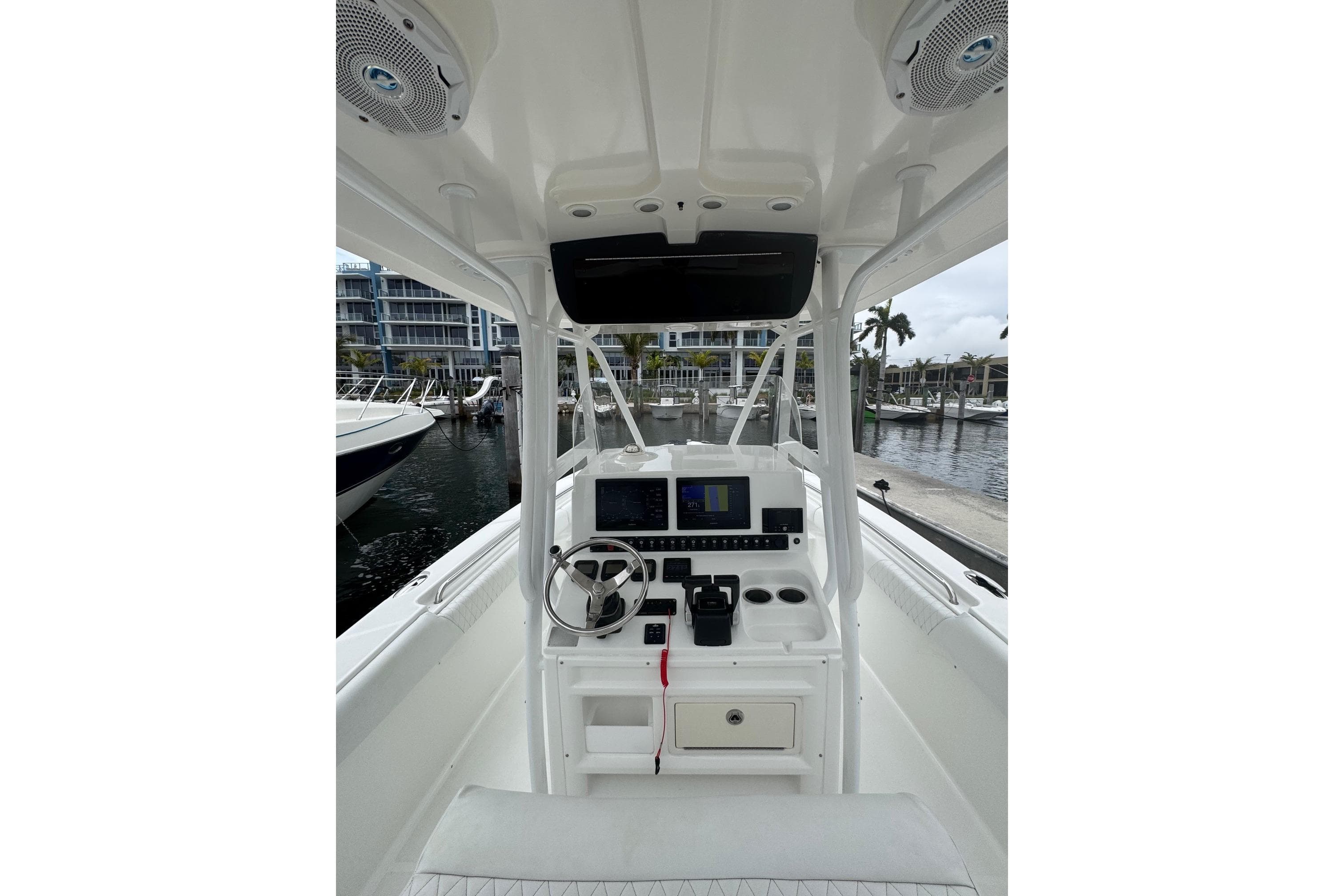 2011 Sea Hunt Gamefish 27 boat interior with steering wheel and navigation system.