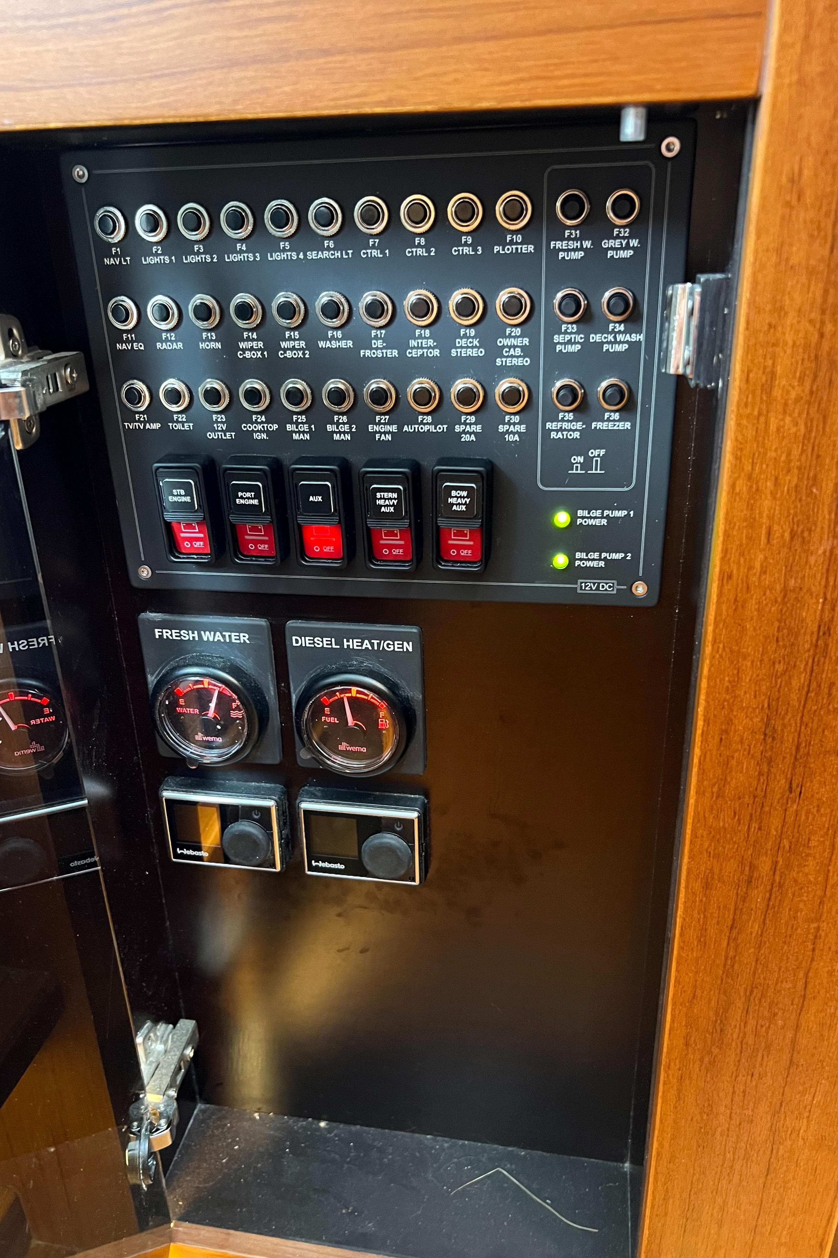 Electrical panel inside 2021 Nimbus Tender 11 boat, featuring switches and gauges.