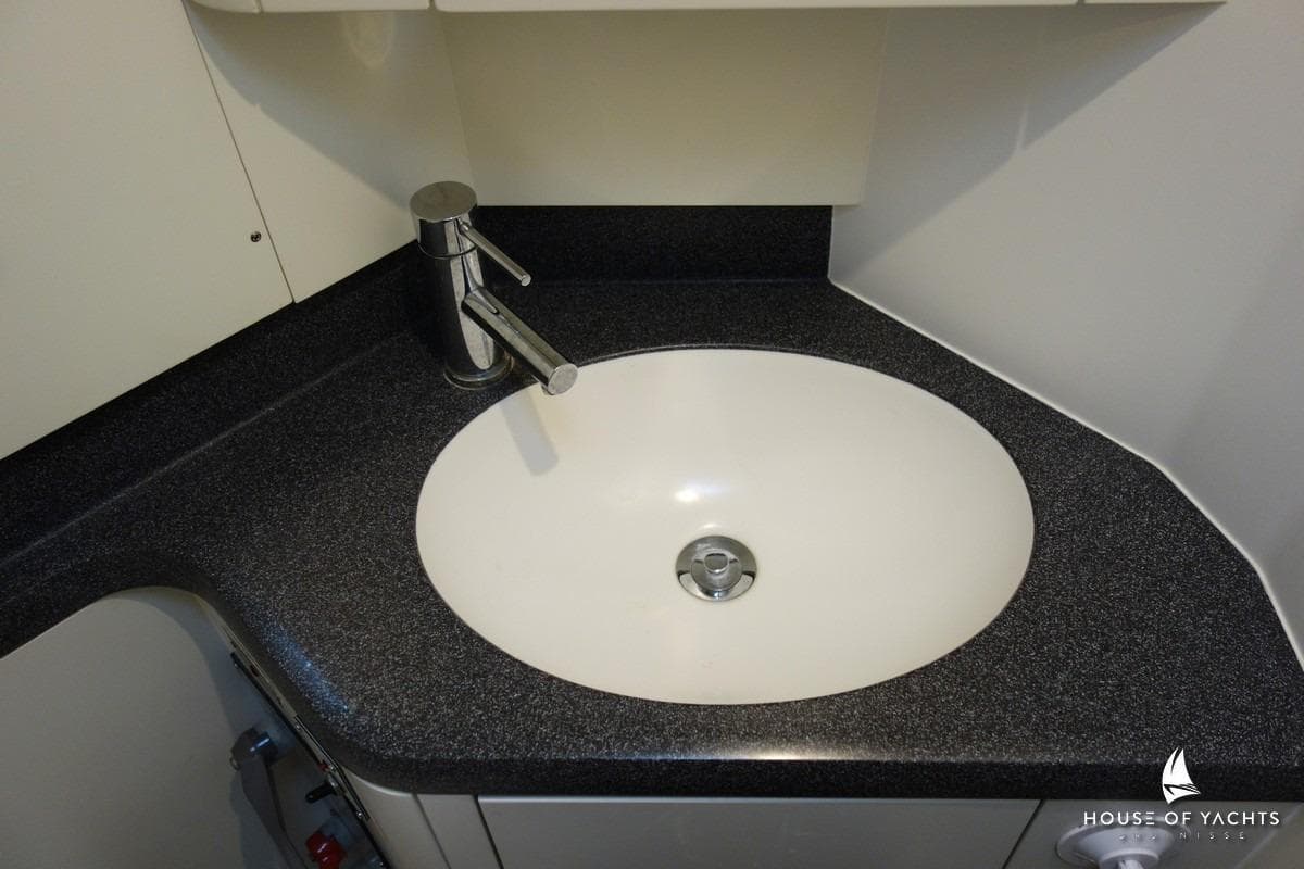 Modern bathroom sink in 2007 Najad 440 AC yacht with sleek faucet design.