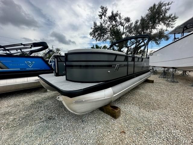 2023 Viaggio Lago C pontoon boat on gravel lot, overcast sky.
