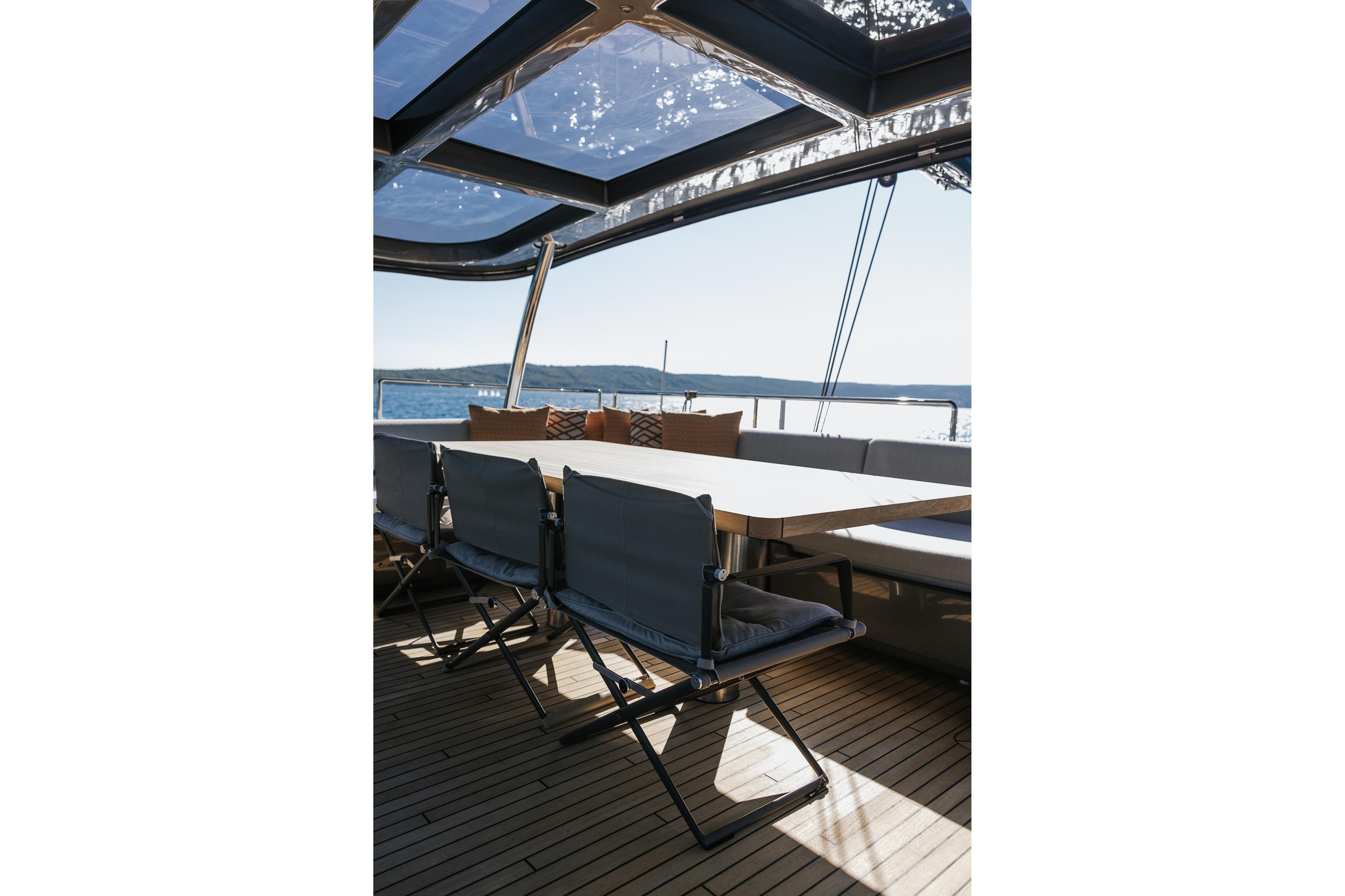 Luxurious Sunreef 60 yacht deck with seating, showcasing modern design and ocean view, 2025 model.