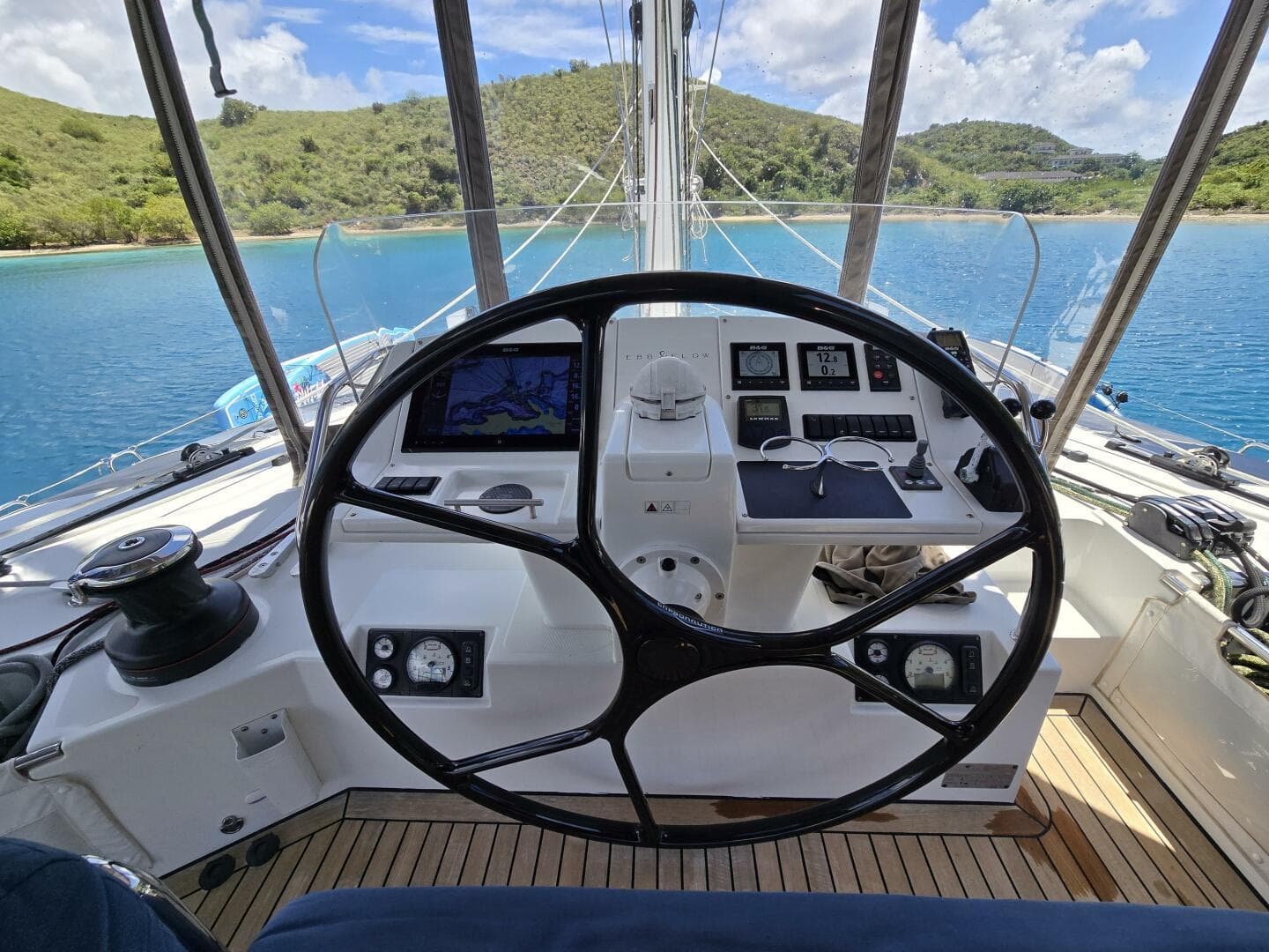 Helm of 2016 Lagoon 560 S2 yacht with scenic ocean and island view.