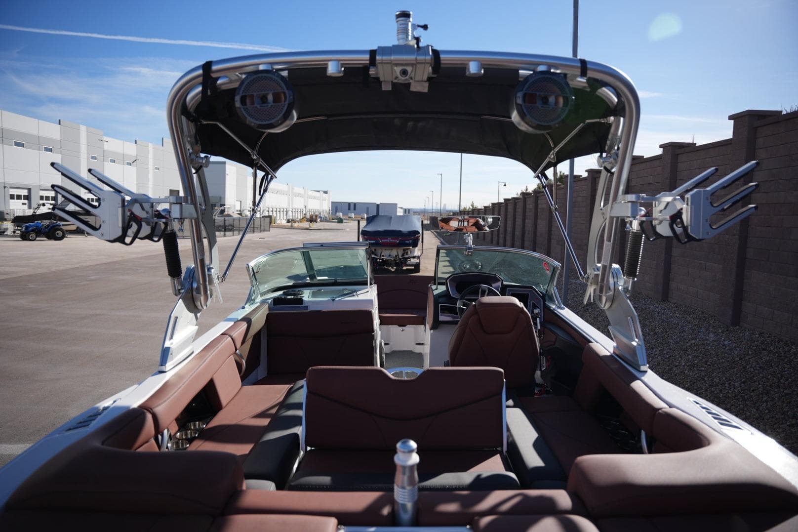 2019 MasterCraft XT22 boat interior with seating and wakeboard racks, parked outdoors.