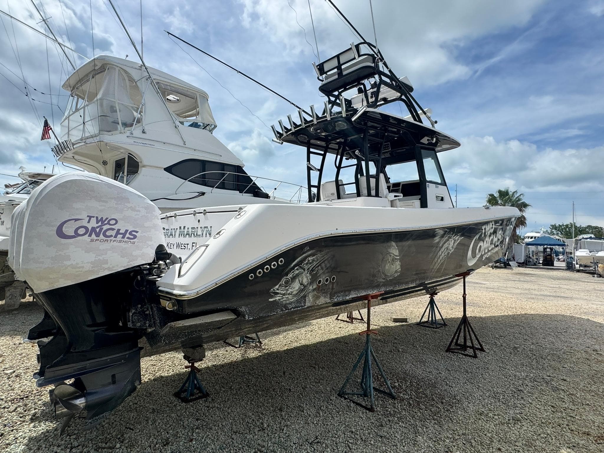 2016 Everglades 355 Tournament boat on stands, featuring "Two Conchs" branding.