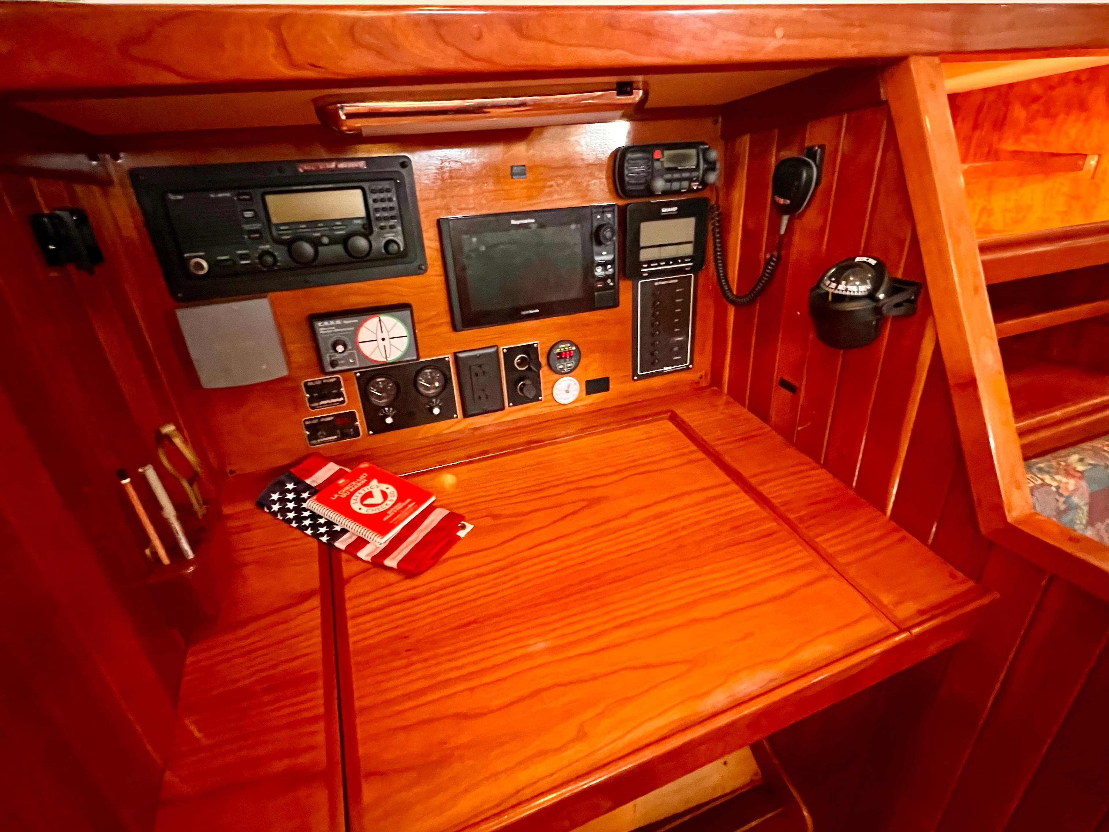 Navigation station of 2001 Shannon 43 Cutter with communication equipment and wooden finish.