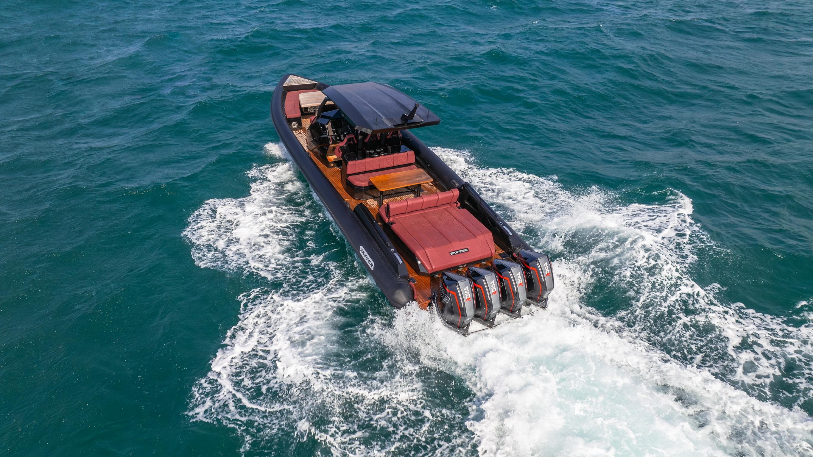 2025 Skipper-BSK 42NC boat cruising on open water with powerful engines.