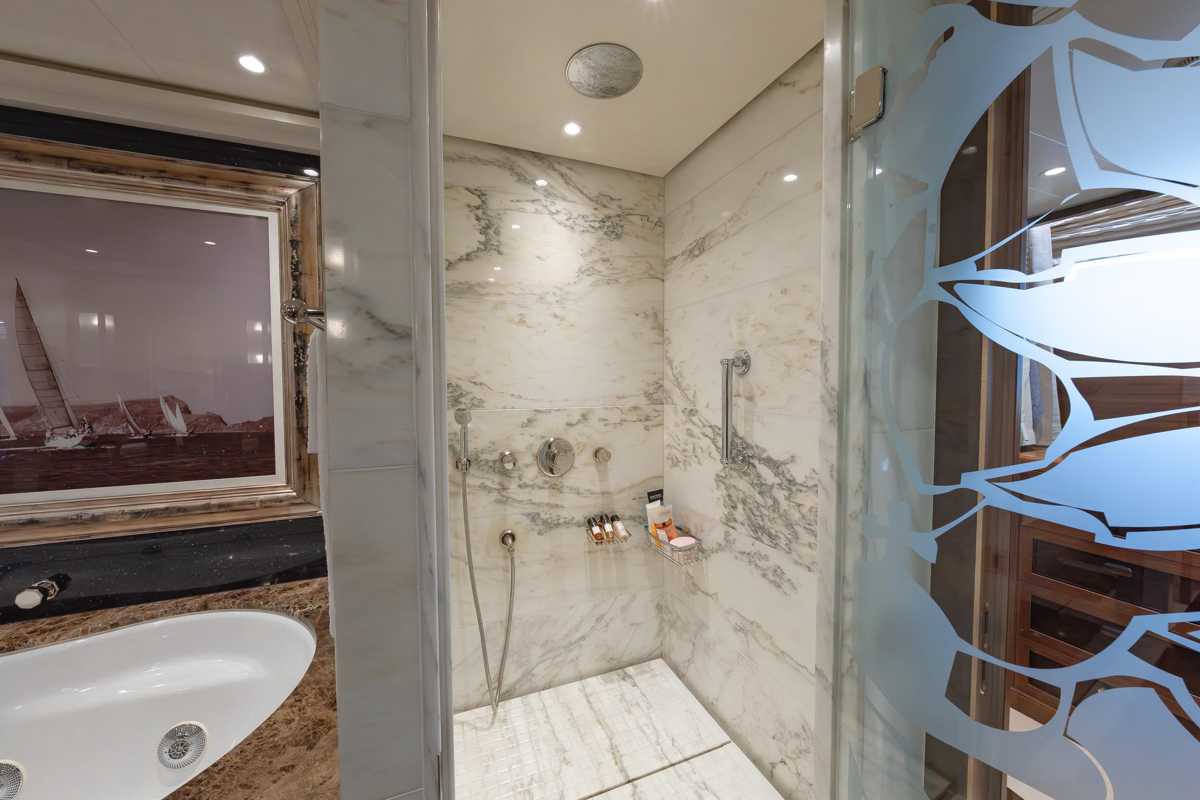 Luxurious marble bathroom on 2009 Timmerman Expedition Tri-Deck yacht with elegant shower and bathtub.