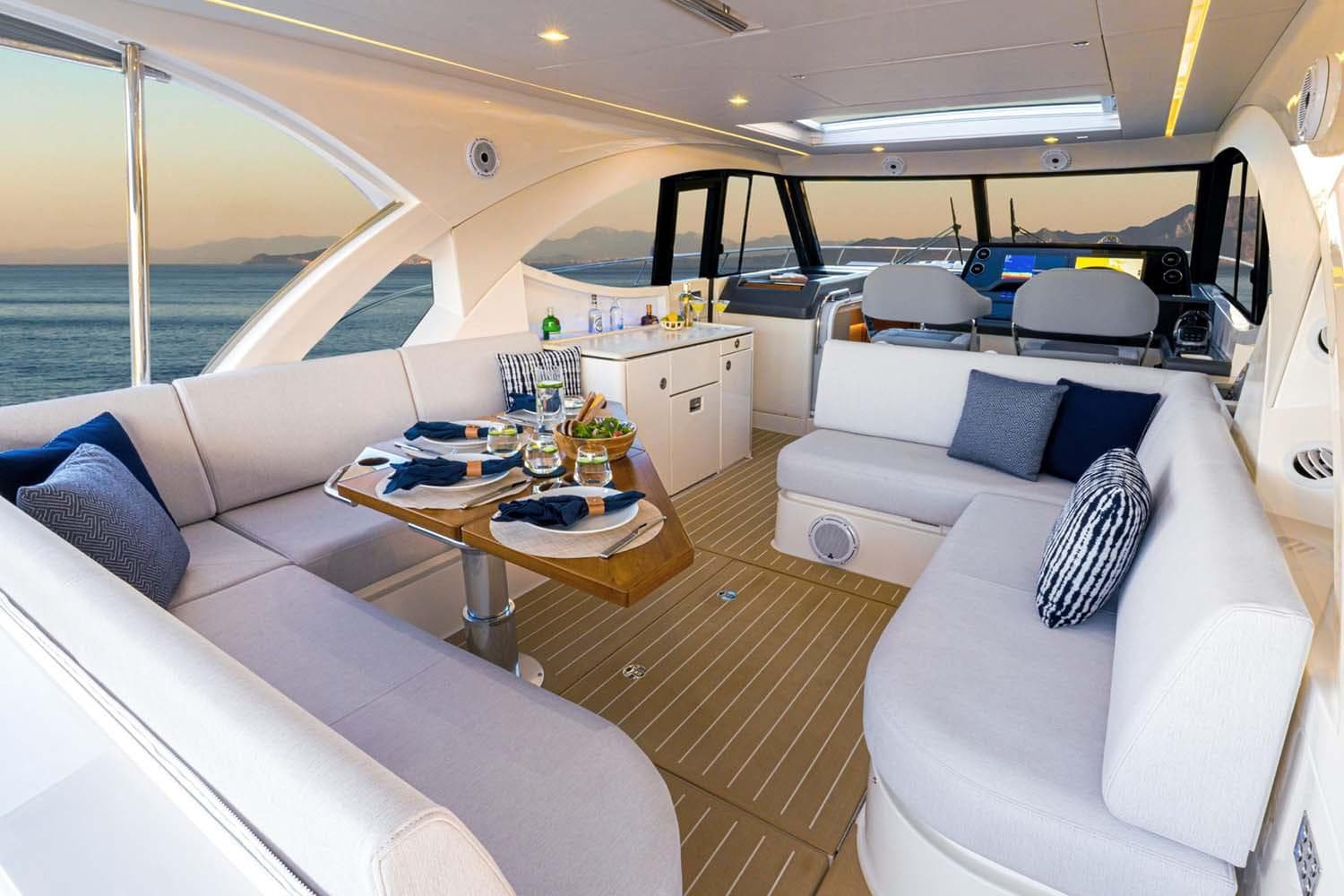 Manufacturer Provided Image: Luxurious interior of 2026 Riviera 4300 Sport Express yacht with elegant seating and dining area.