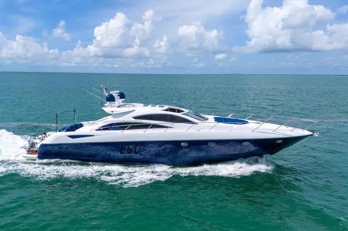 2006 Sunseeker Predator 72 yacht cruising on open sea under blue sky.