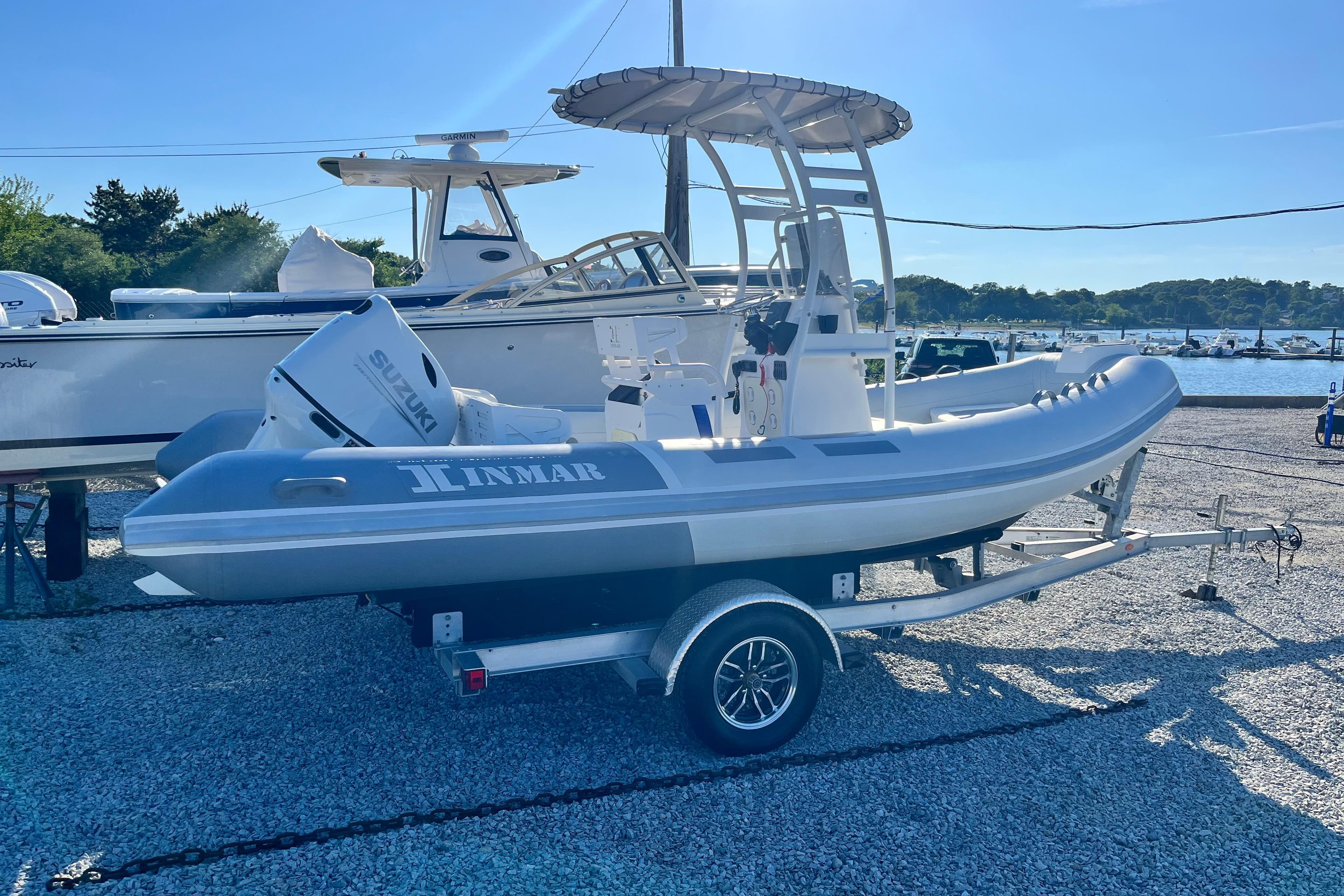 2023 Inmar 550R-YS Yacht Series boat on trailer, featuring Suzuki outboard motor.