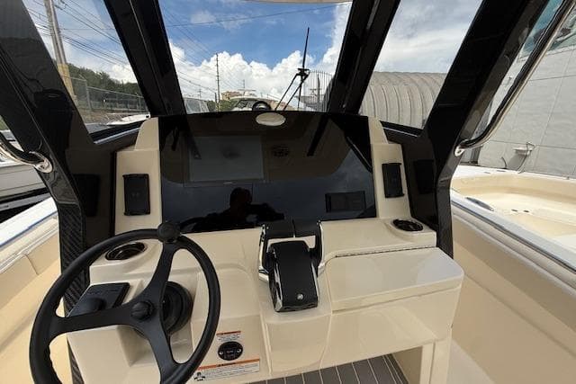 2026 Scout 288 LXF boat dashboard with steering wheel and controls.