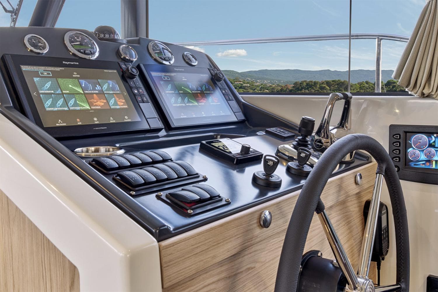 Manufacturer Provided Image: Helm of 2026 Beneteau Swift Trawler 48 with advanced navigation displays and controls.