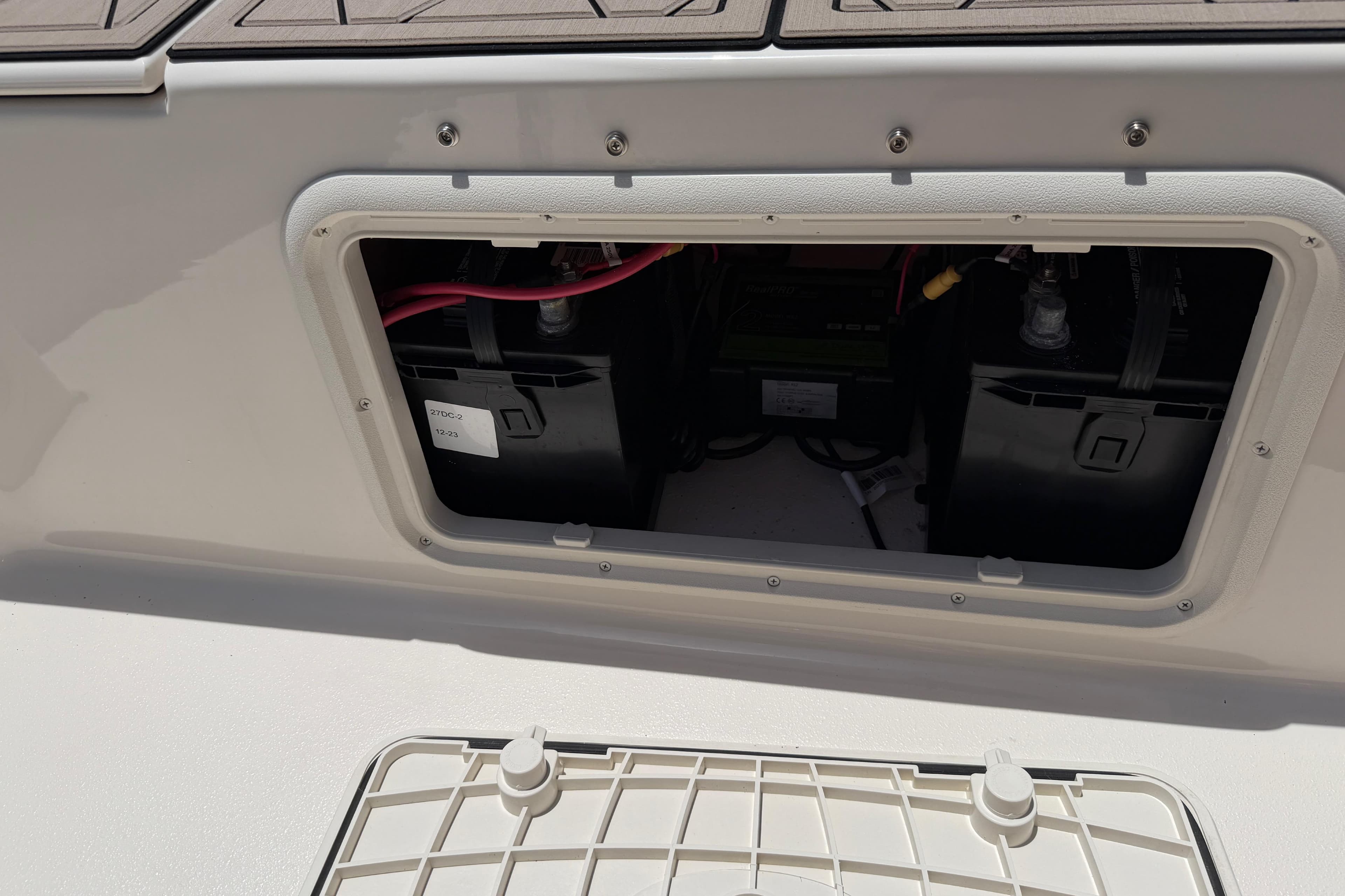 Battery compartment of 2023 Carolina Skiff 21 LS boat, showcasing internal components.