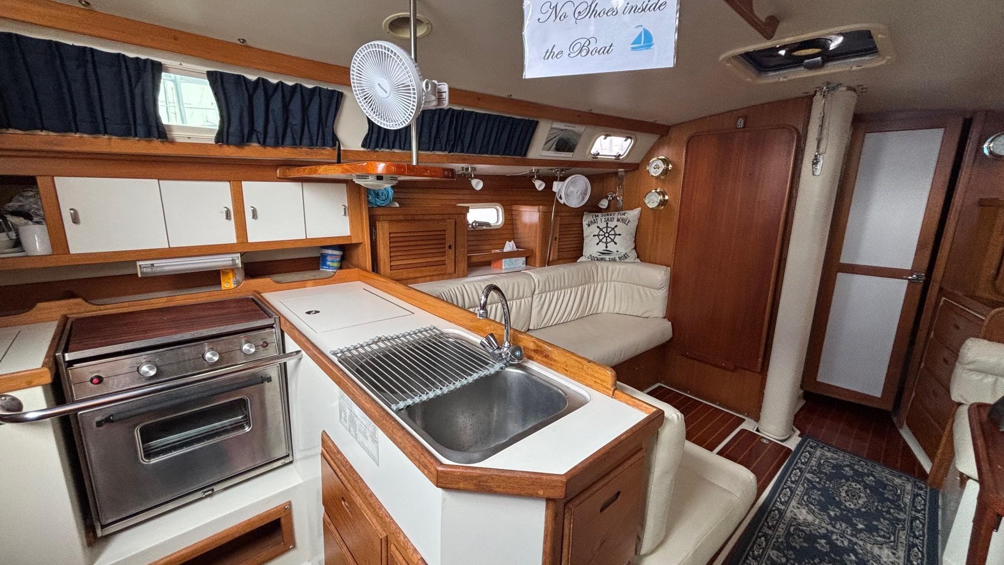 Interior of a 1994 Catalina 36 sailboat with kitchen and seating area.