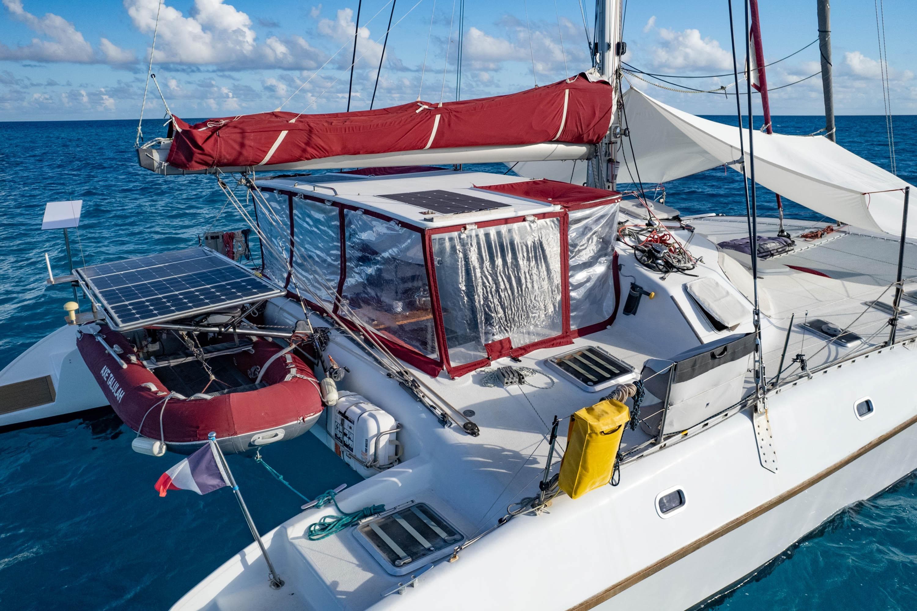 Sailing catamaran "ville Audrain 45" with solar panels, anchored in clear blue ocean, 2001 model.