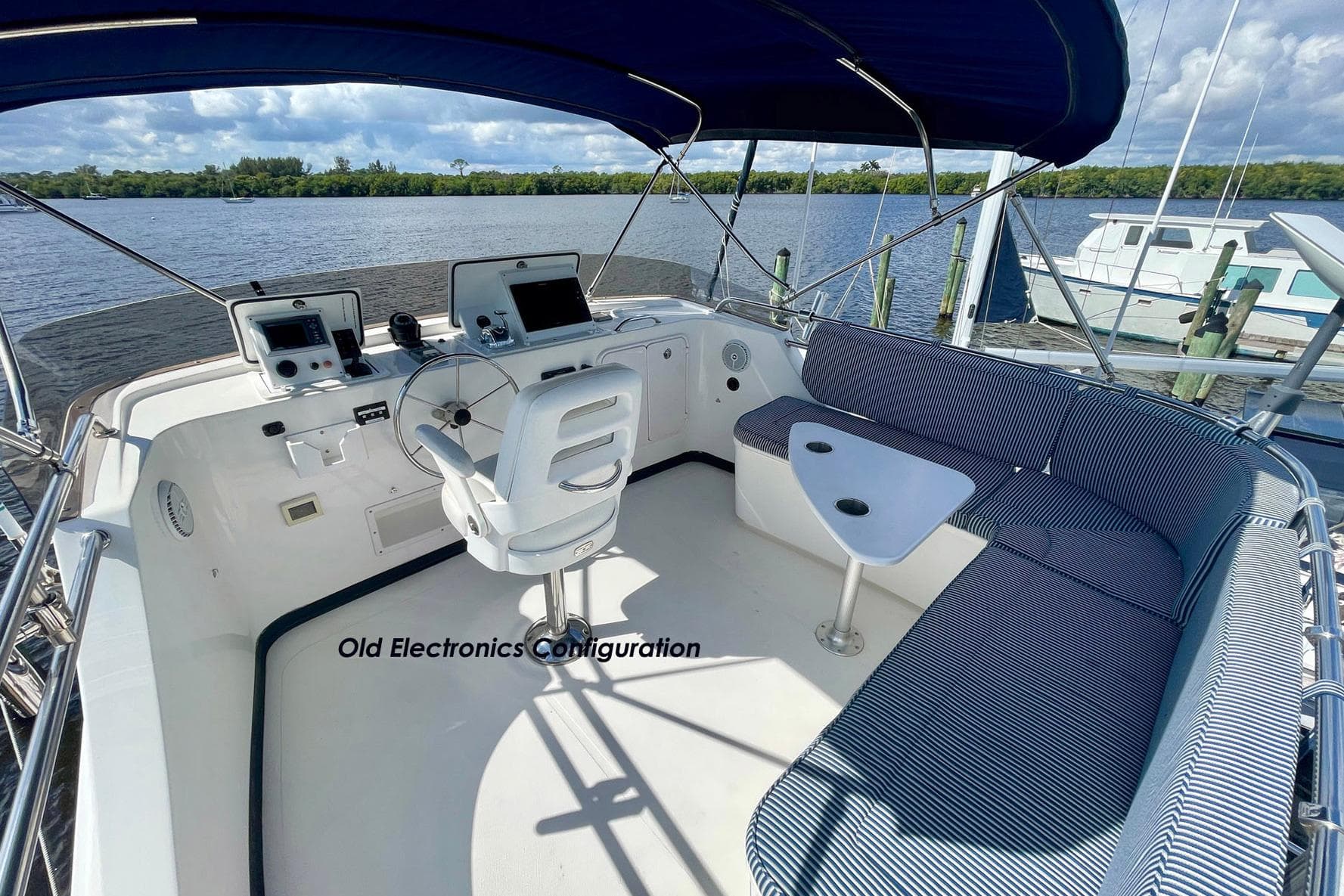 2008 Nordic Tug 42 boat helm with old electronics, featuring seating and water view.