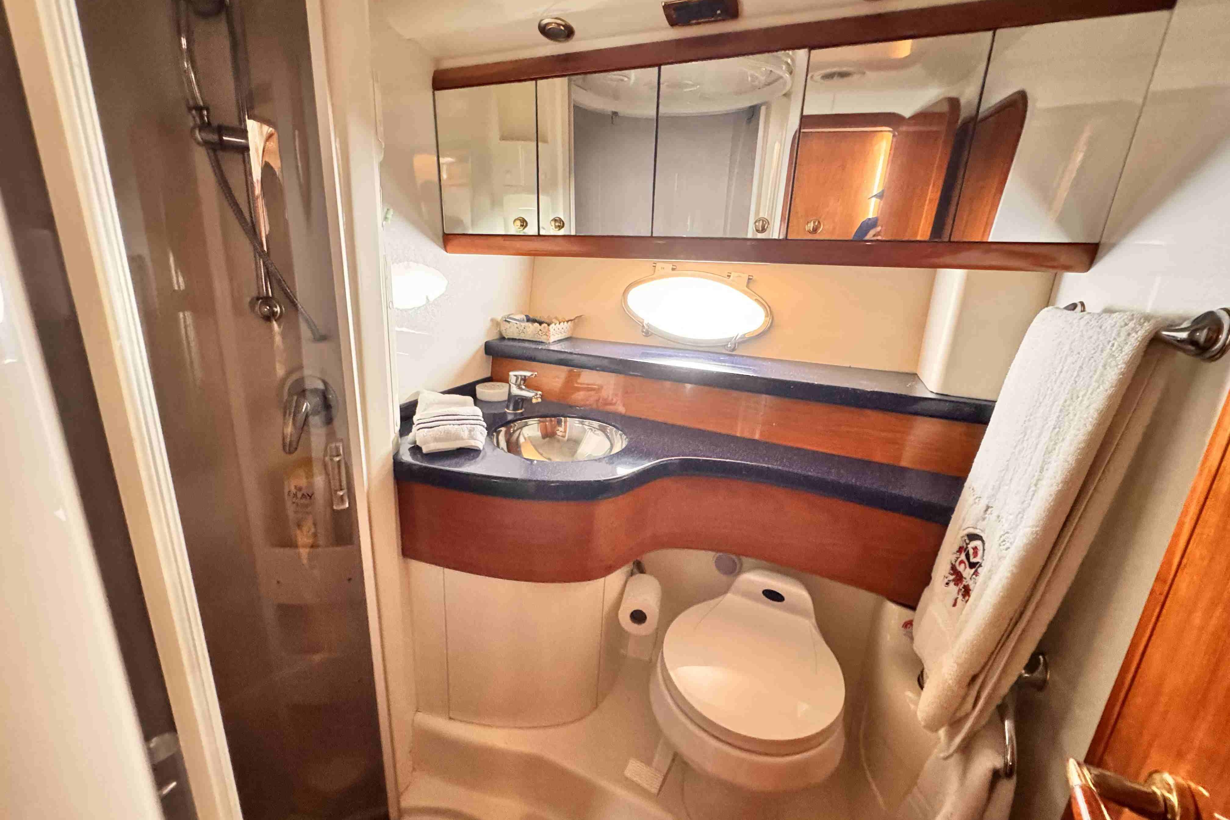 Luxurious Cranchi yacht bathroom with modern fixtures, shower, and elegant wood accents.