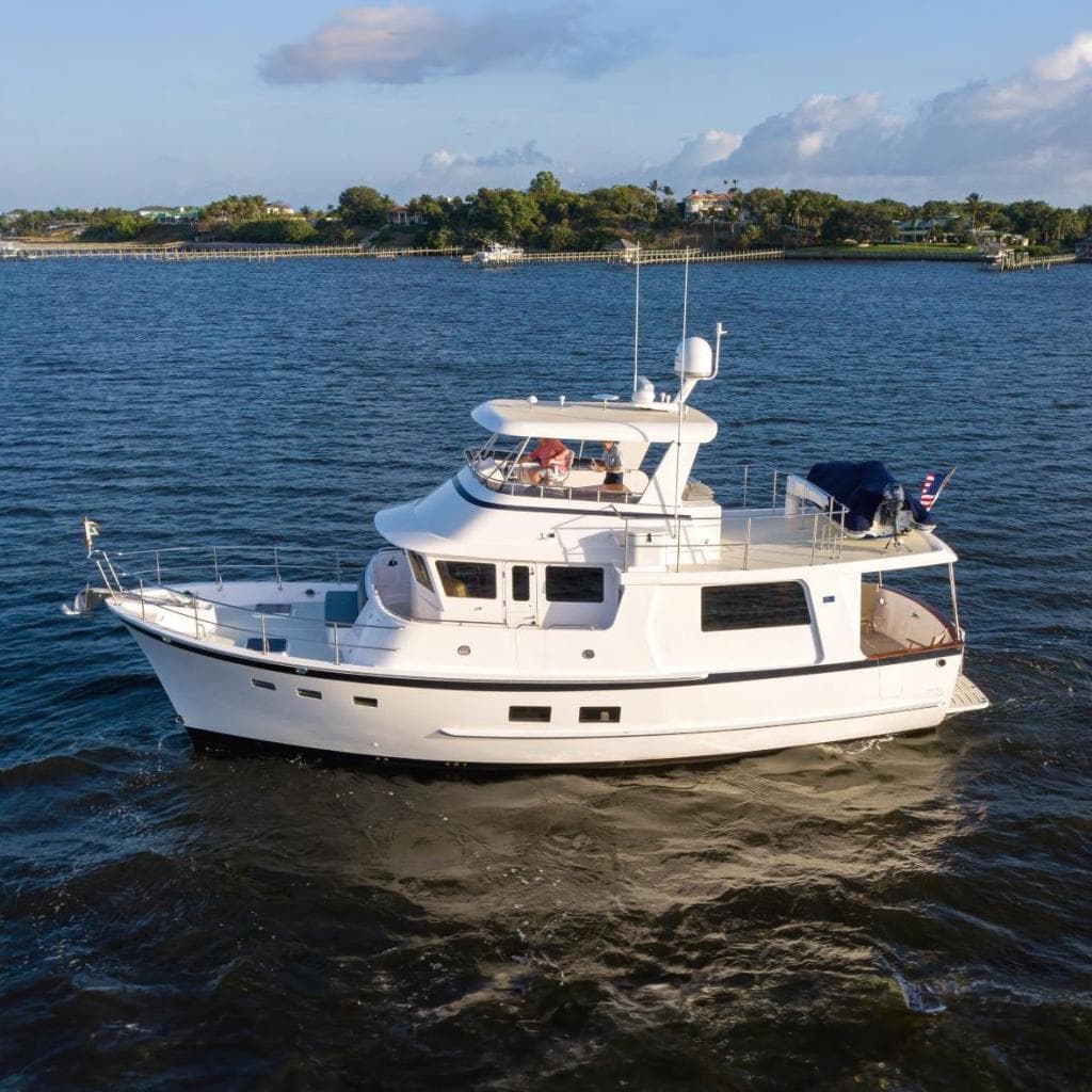 Kadey-Krogen 50 Open 2021 yacht cruising on calm waters under a clear sky.