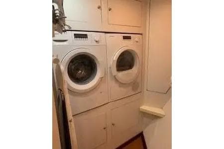 Laundry area in 1997 Broward raised pilot house M/Y yacht with stacked washer and dryer.
