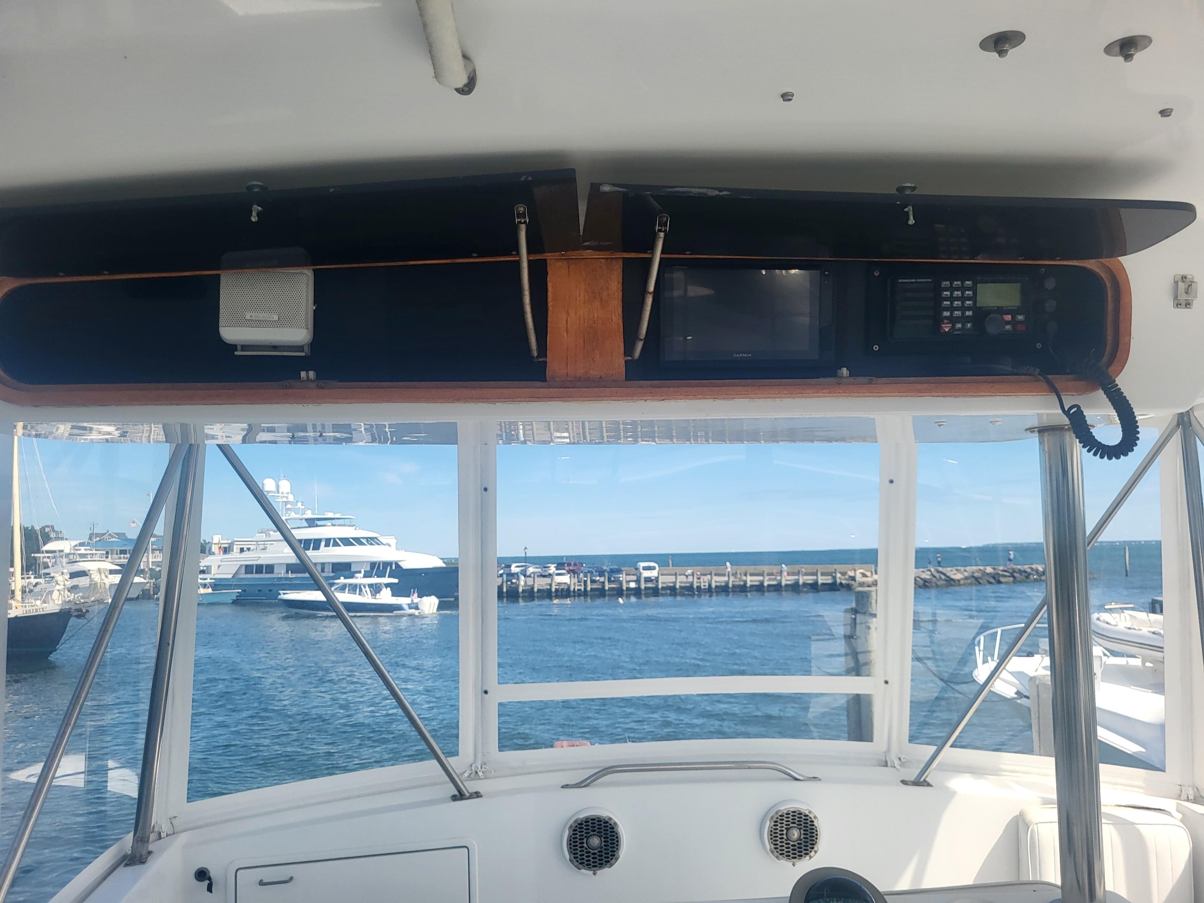 Interior view of 1989 Ocean Yachts 48, featuring navigation equipment and ocean backdrop.