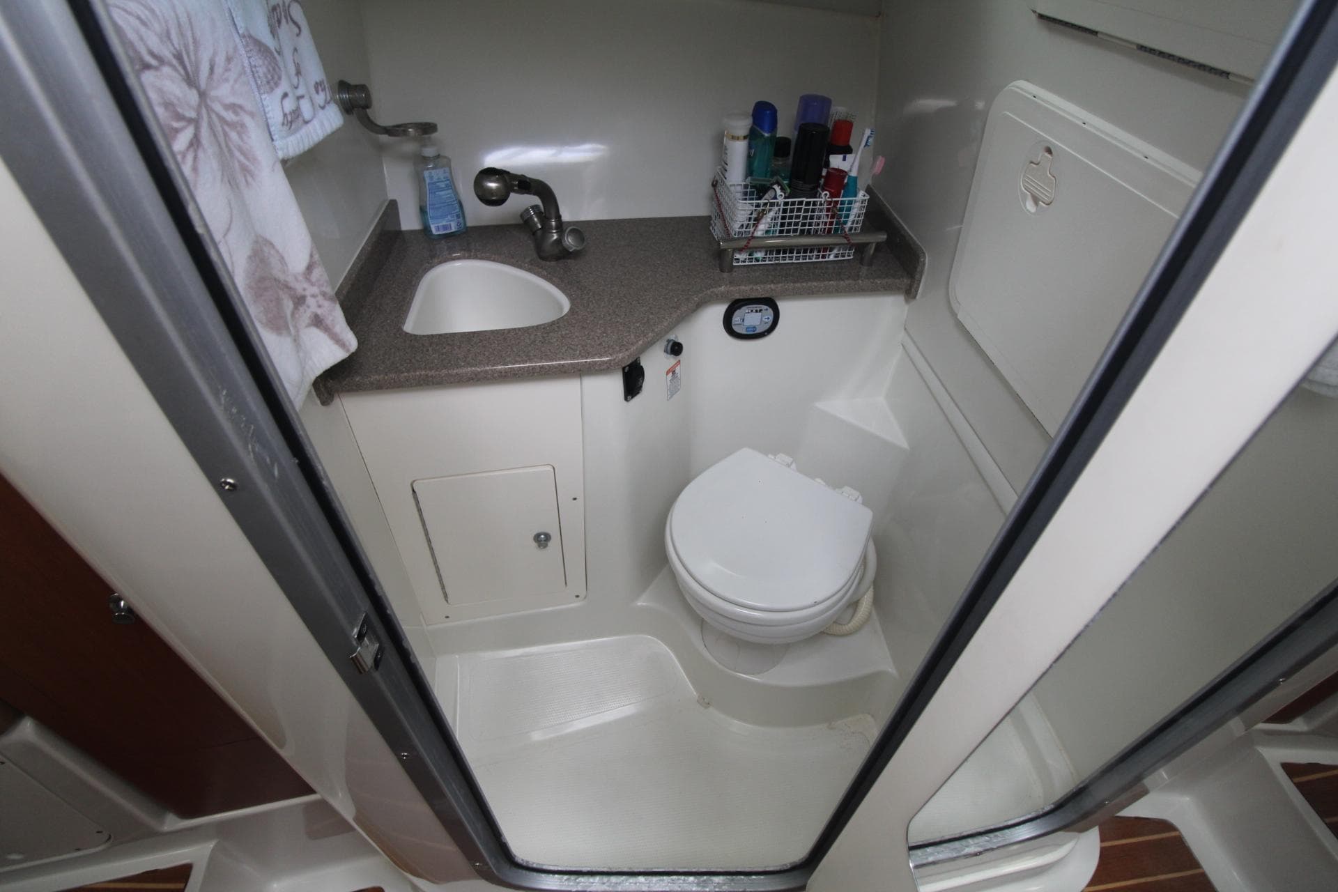 2007 Sailfish 3006 WALKAROUND boat bathroom with sink, toilet, and storage.