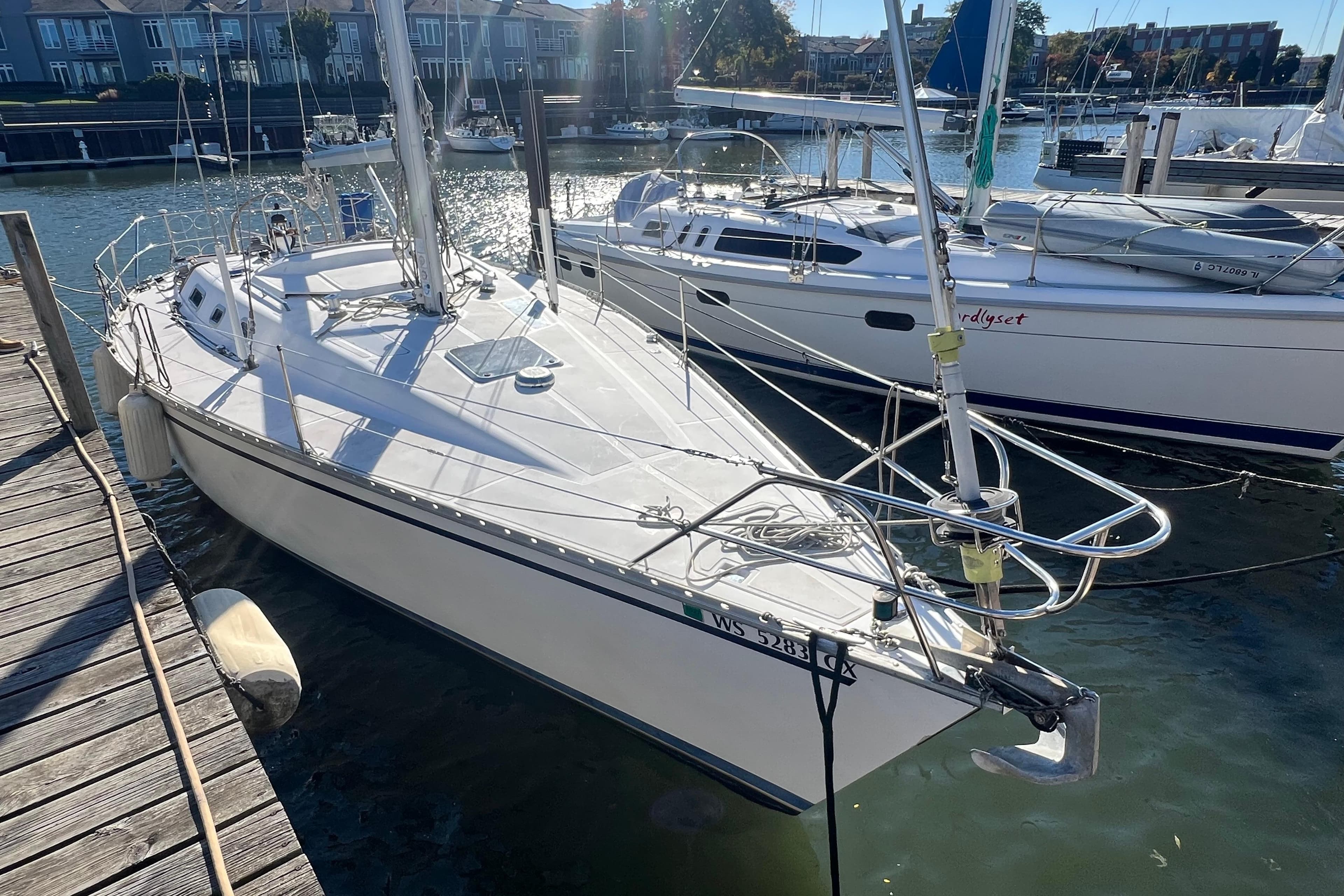 1987 Hunter Legend 37 sailboat docked at marina, sunny day, calm waters.