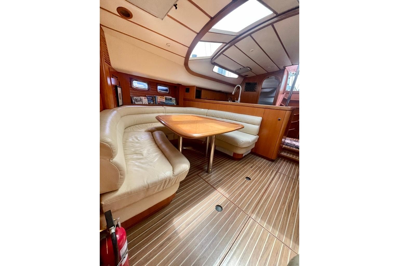 Luxurious 1997 Feeling 546 yacht interior with leather seating and wooden accents.
