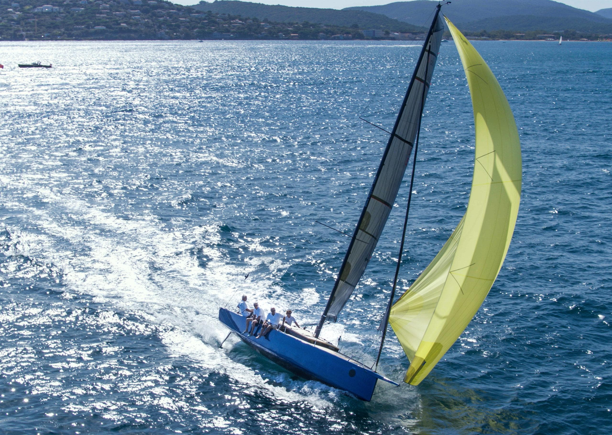 Sleek Black Pepper Code 0.1 sailboat with yellow sail gliding on sparkling blue sea, 2025 model.