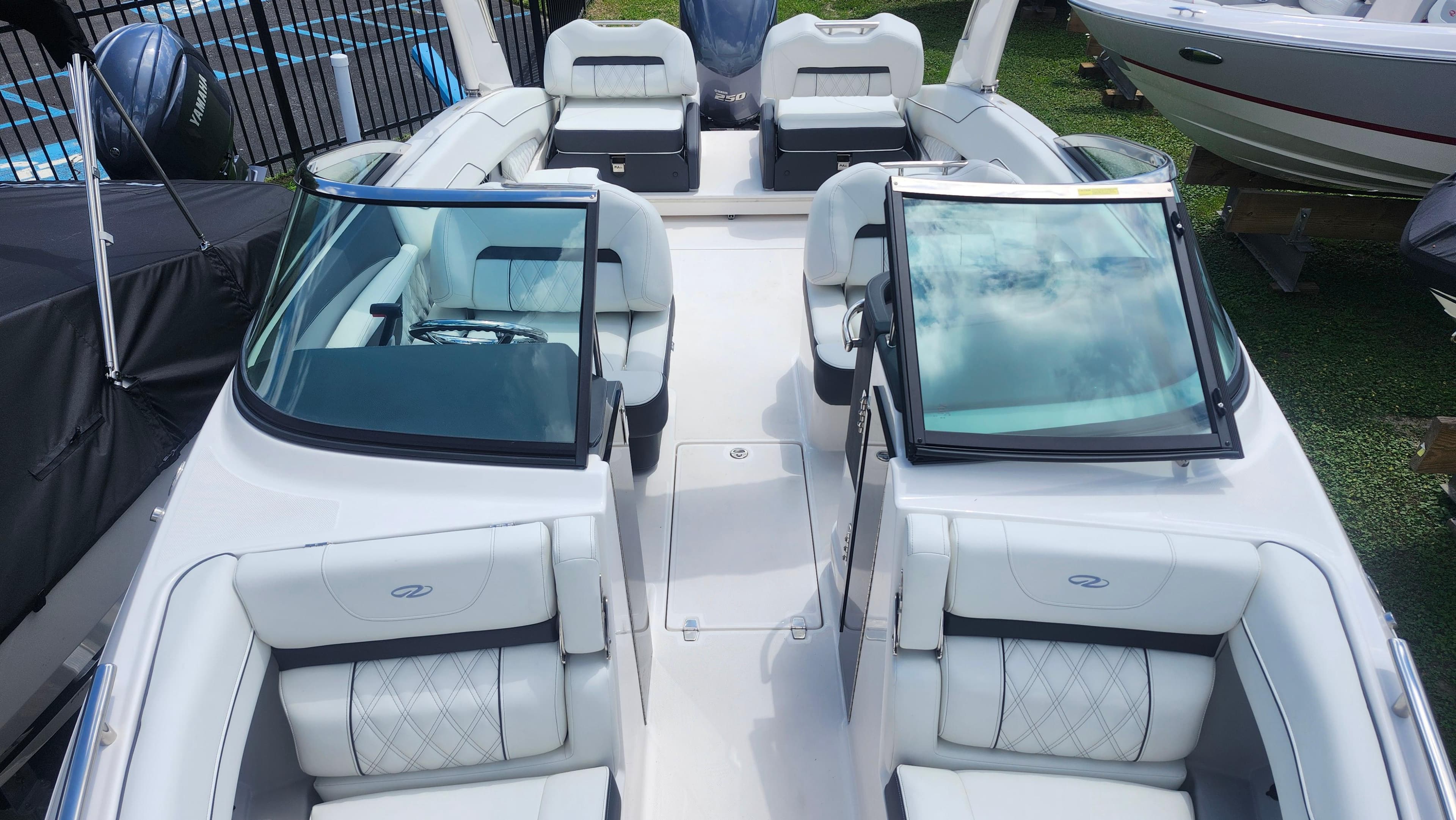 2026 Regal LX4 boat interior with white seating and dual windshields.