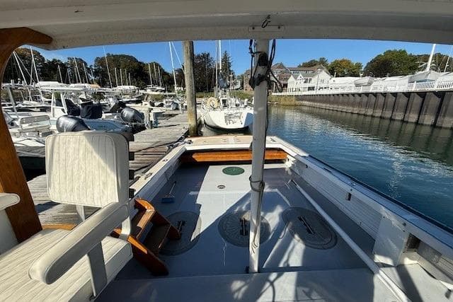 1975 Jarvis Newman 32 DEC boat docked at a marina, showcasing spacious deck and seating.