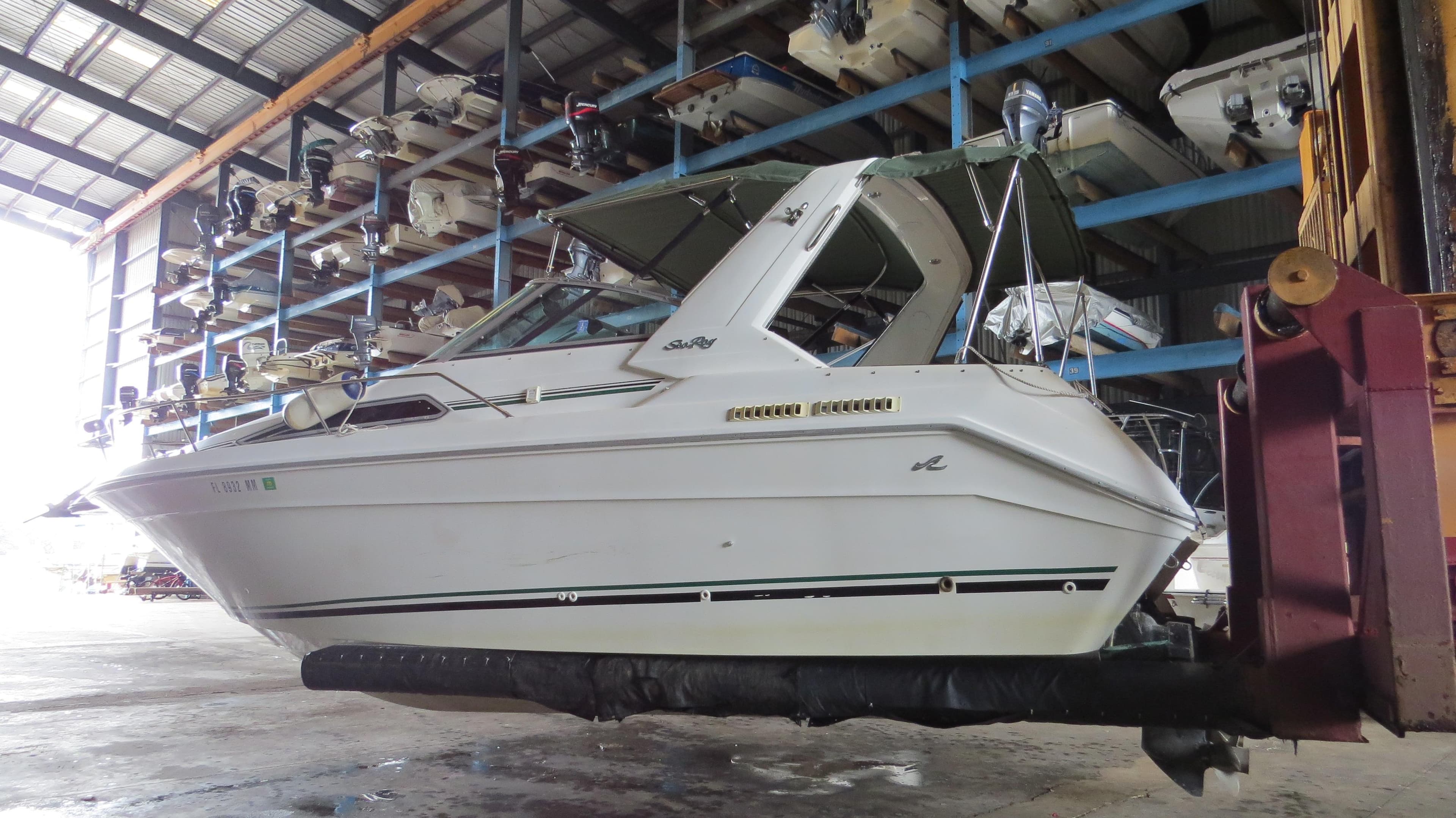 1989 Sea Ray Sundancer 280 boat in storage facility, side view.