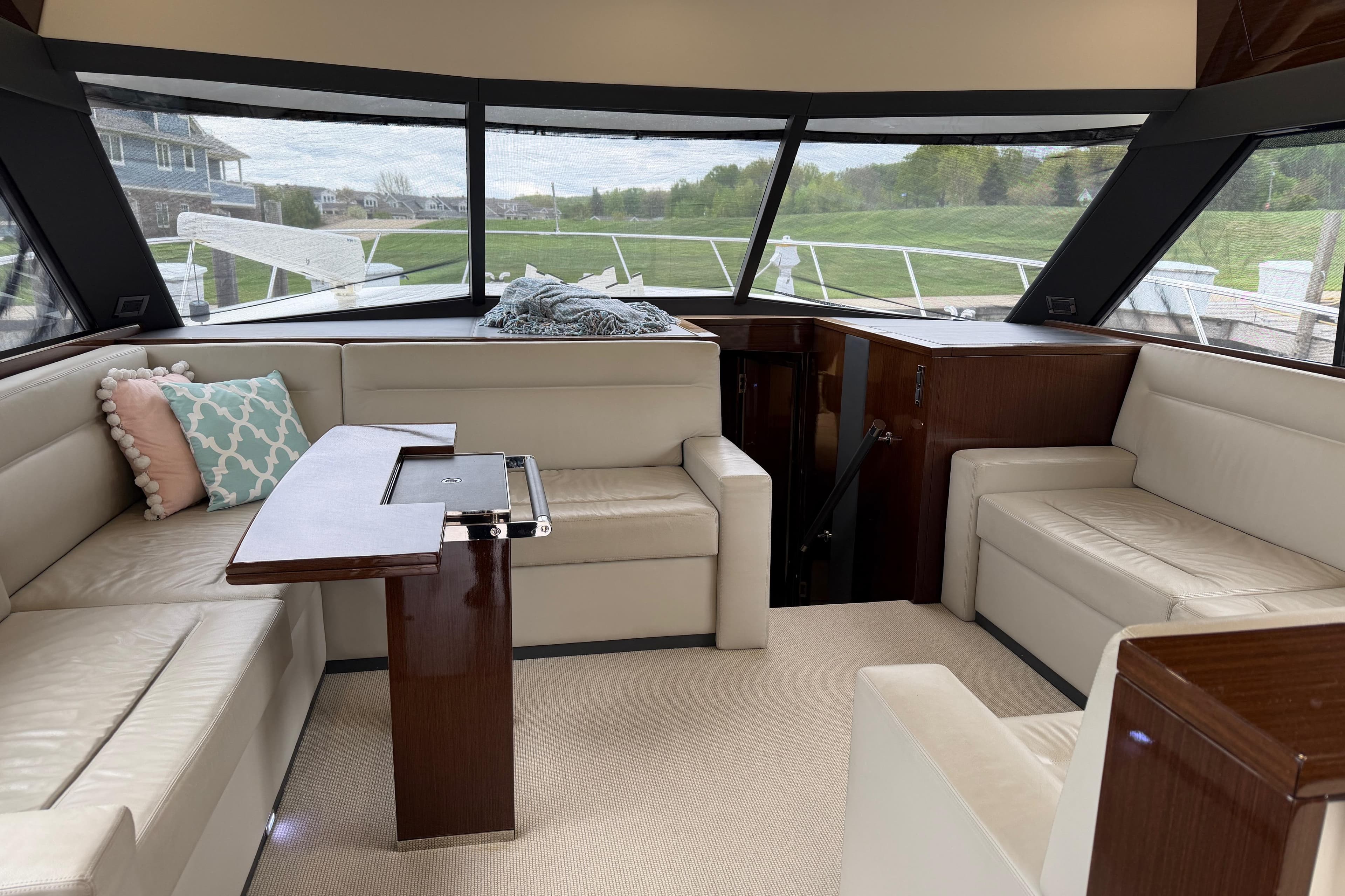 Luxurious interior of 2017 Maritimo M54 yacht with plush seating and elegant wood finishes.