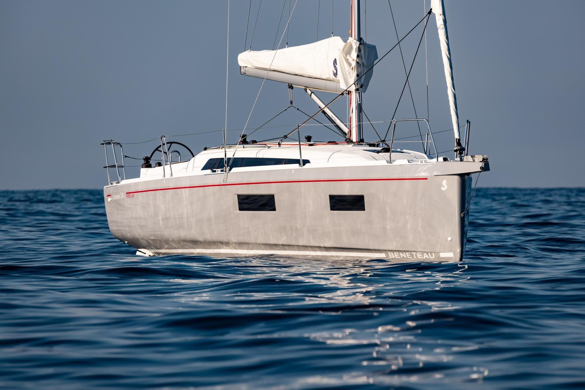 2025 Beneteau Oceanis 34.1 sailboat on calm blue water.