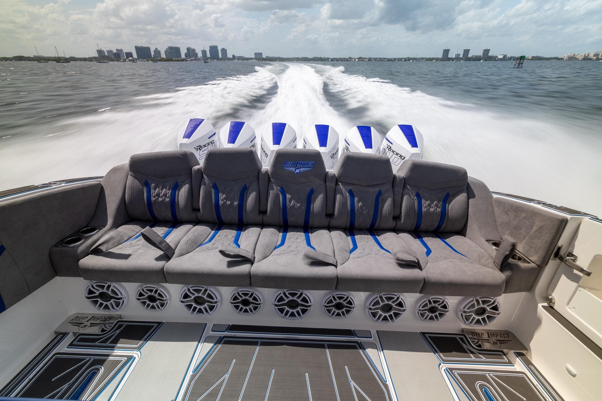 Luxury seating on 2027 Deep Impact 449 Sport boat, cruising at high speed on open water.