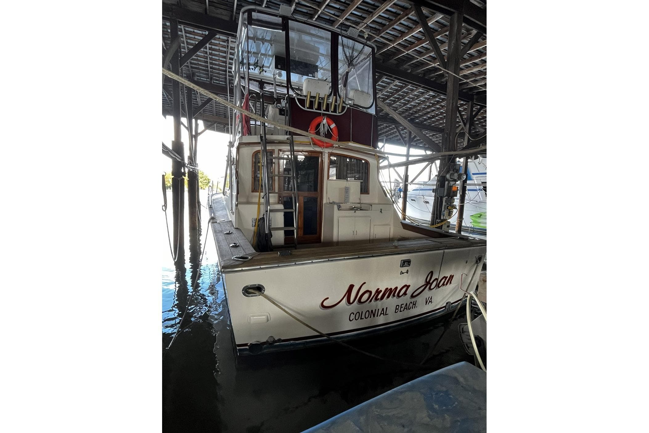 1991 Pace 36 boat docked in a covered marina, named "Norma Jean."