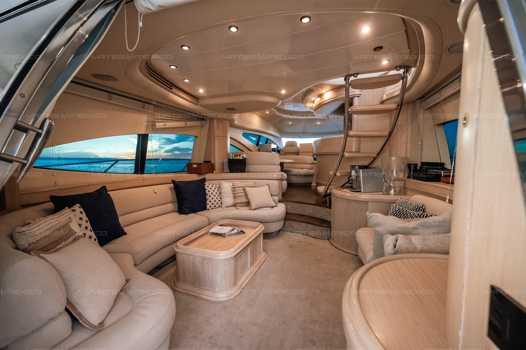 Luxurious interior of a 2004 Azimut 68 Plus yacht with elegant seating and ocean view.