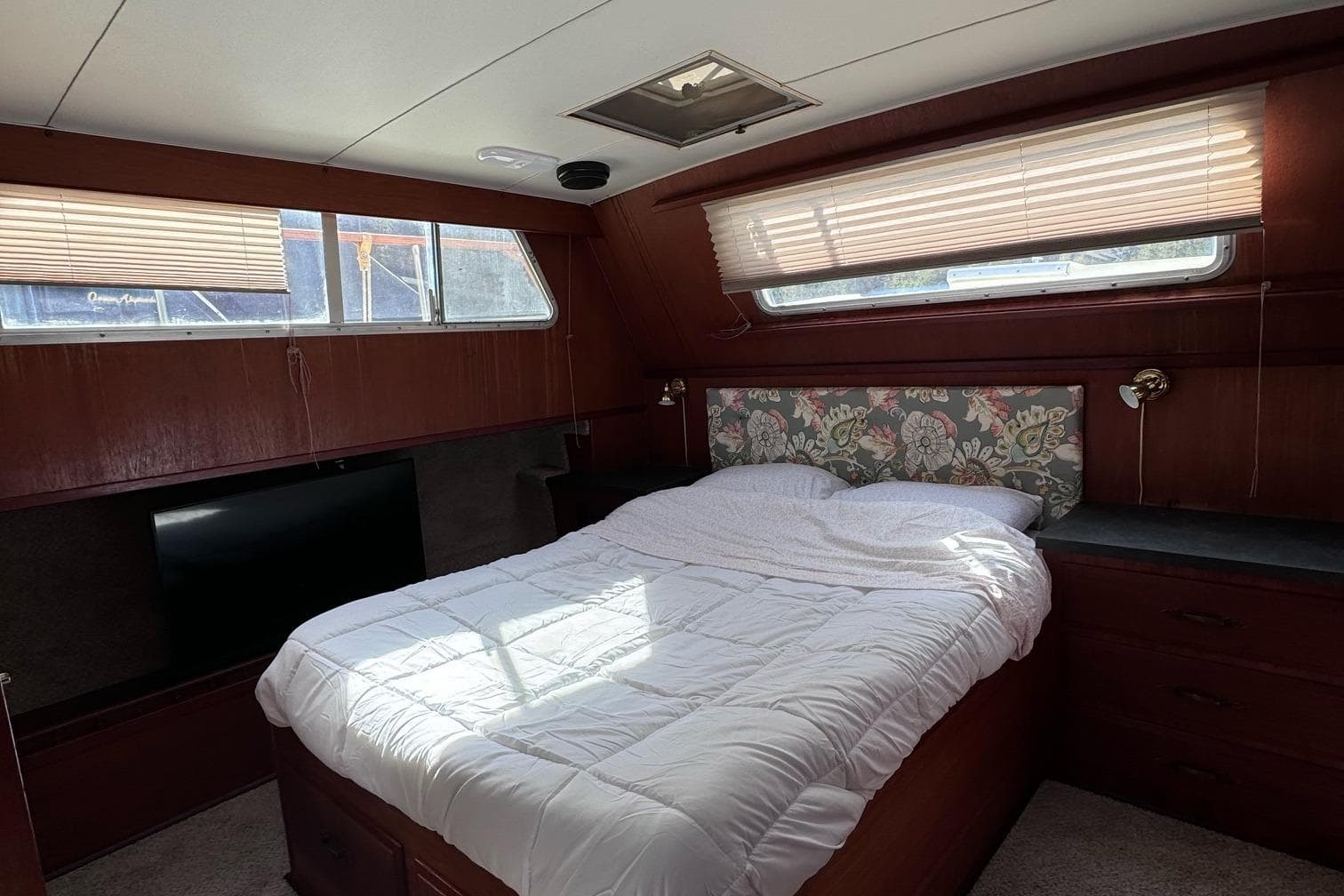1981 Tollycraft 43 Motor Yacht bedroom with floral headboard and natural light.