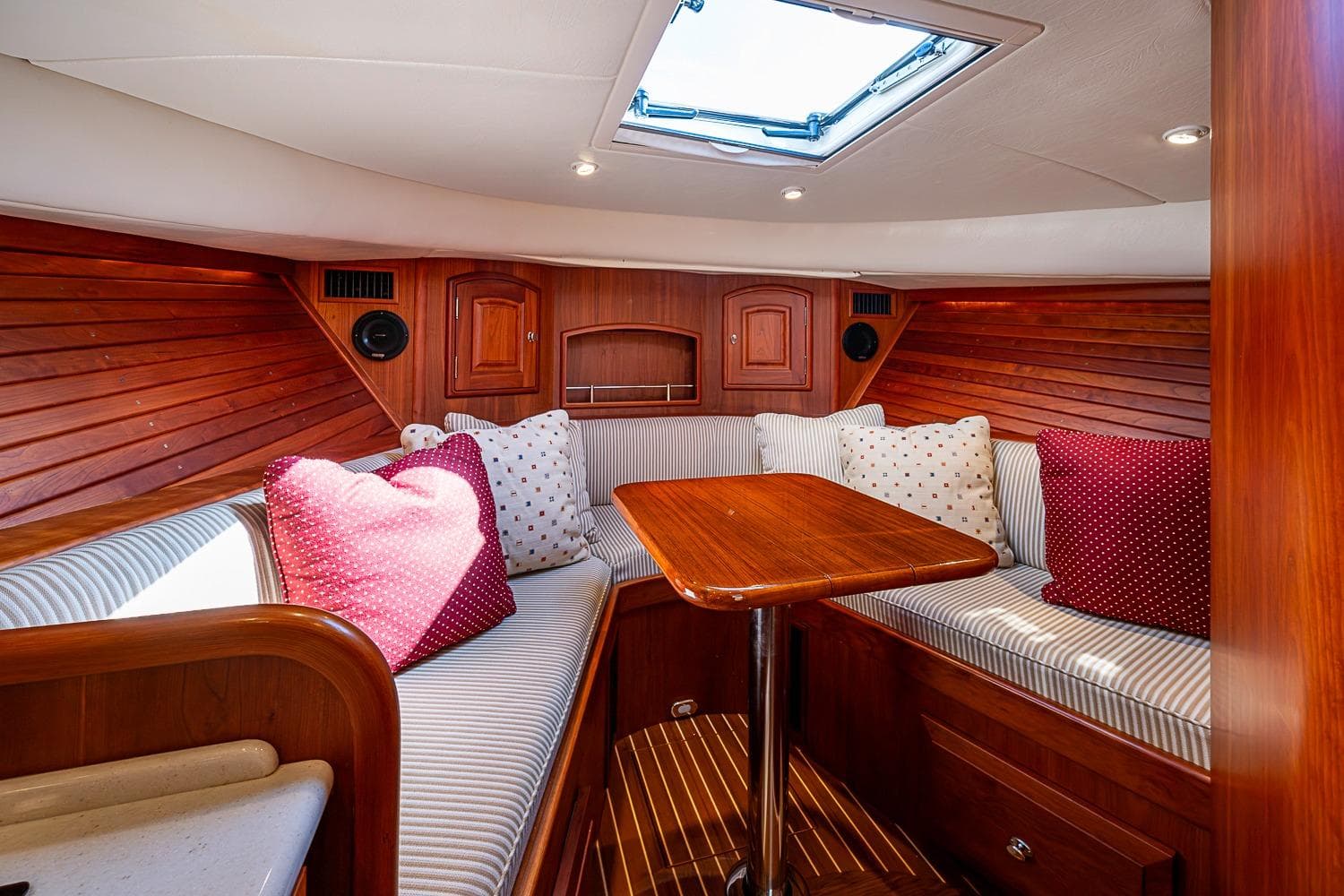 Luxurious interior of 2012 Hinckley Runabout 38 with wood finish and cozy seating.