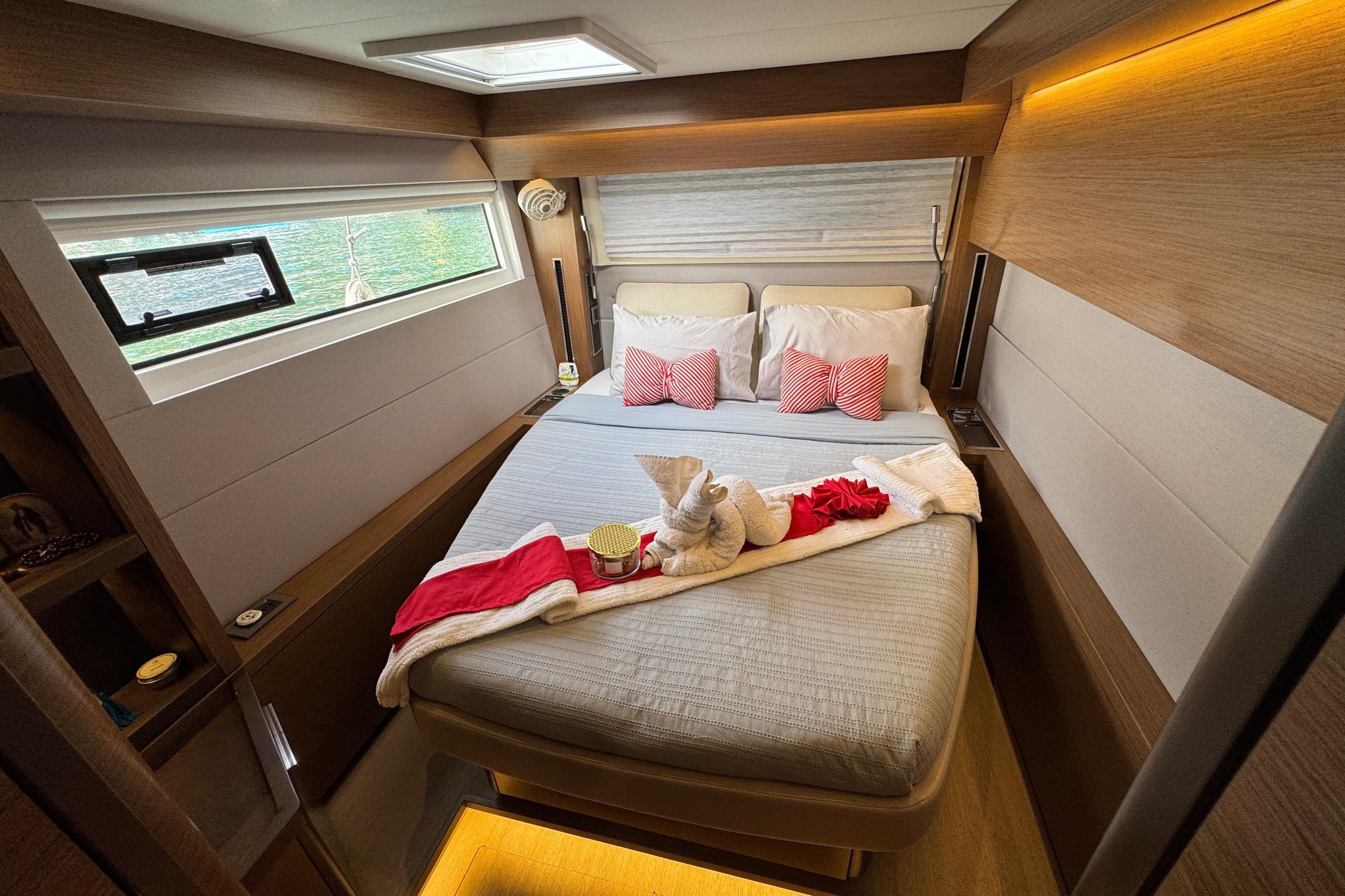 Luxurious cabin interior of 2021 Lagoon 50 yacht with elegant bedding and decor.
