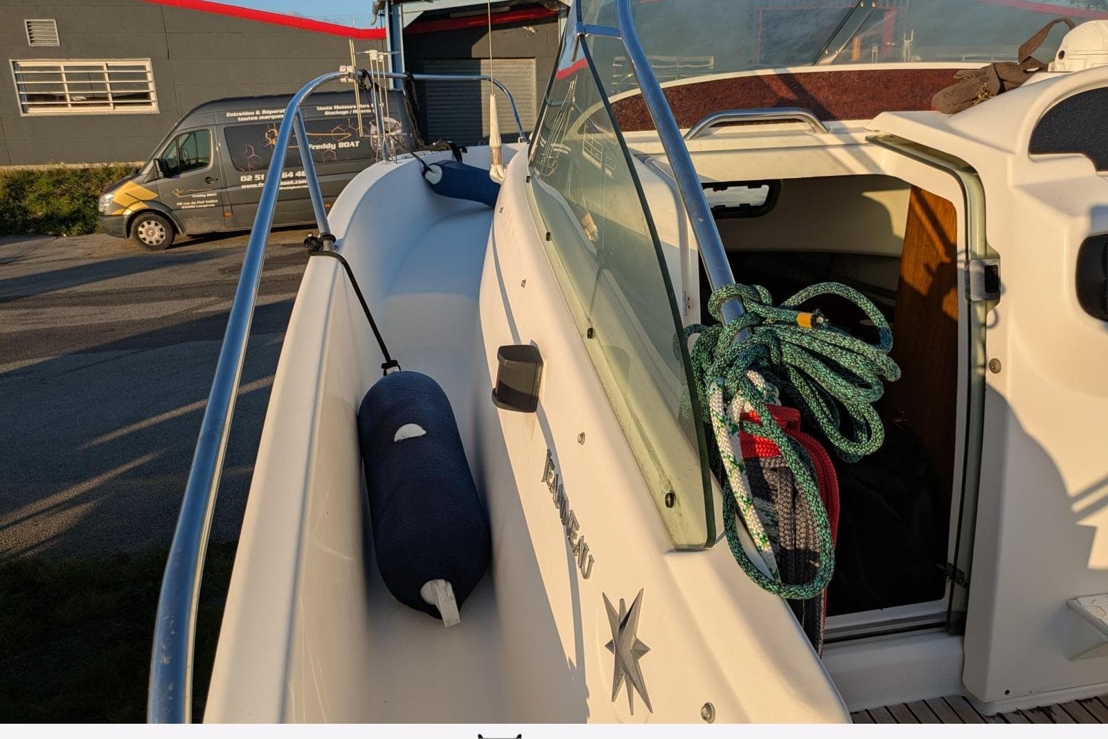 2003 Jeanneau Cap Camarat 755 WA boat with ropes and fender on deck.