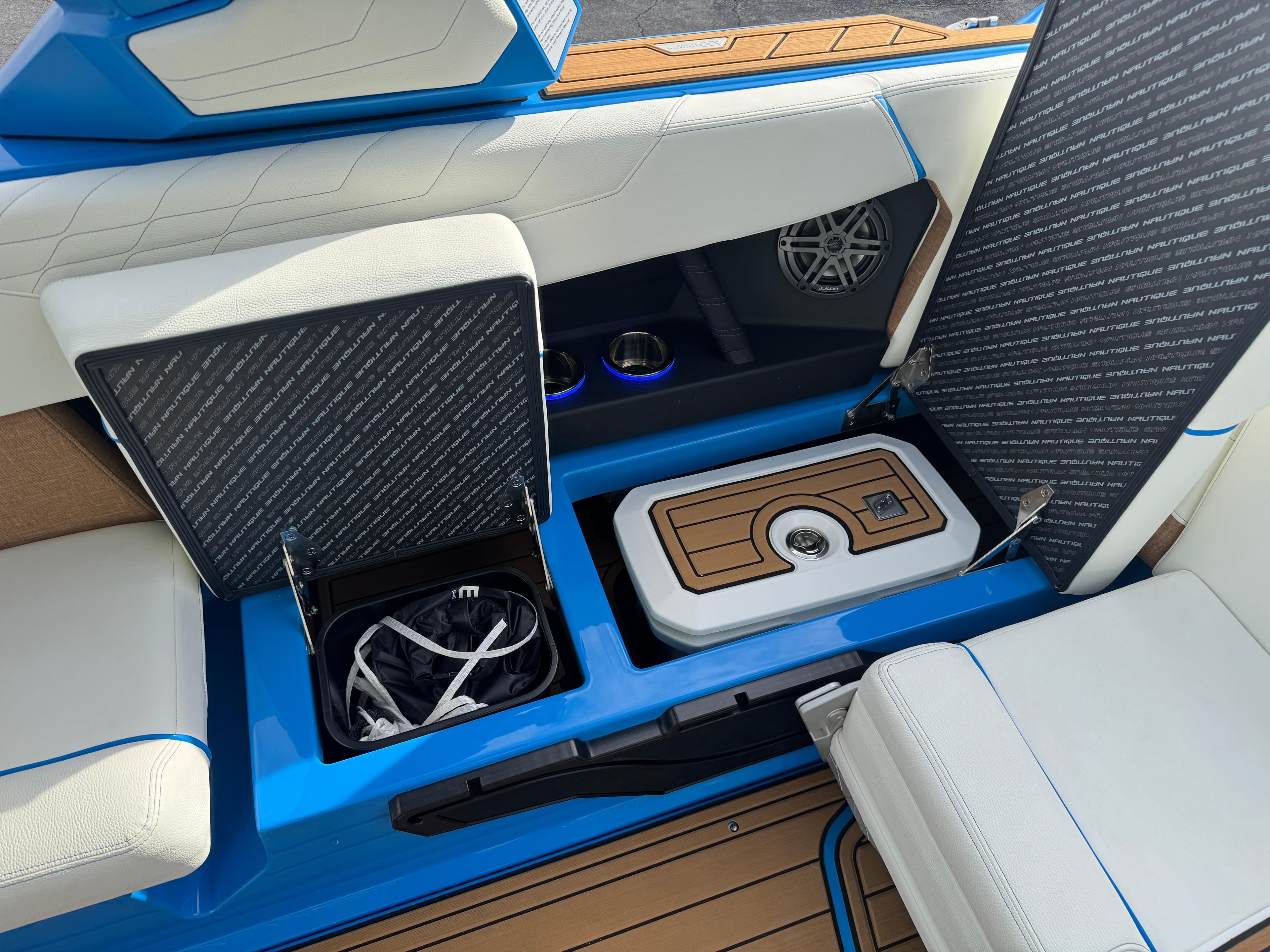 2025 Nautique Super Air Nautique S23 interior with storage compartments and seating.