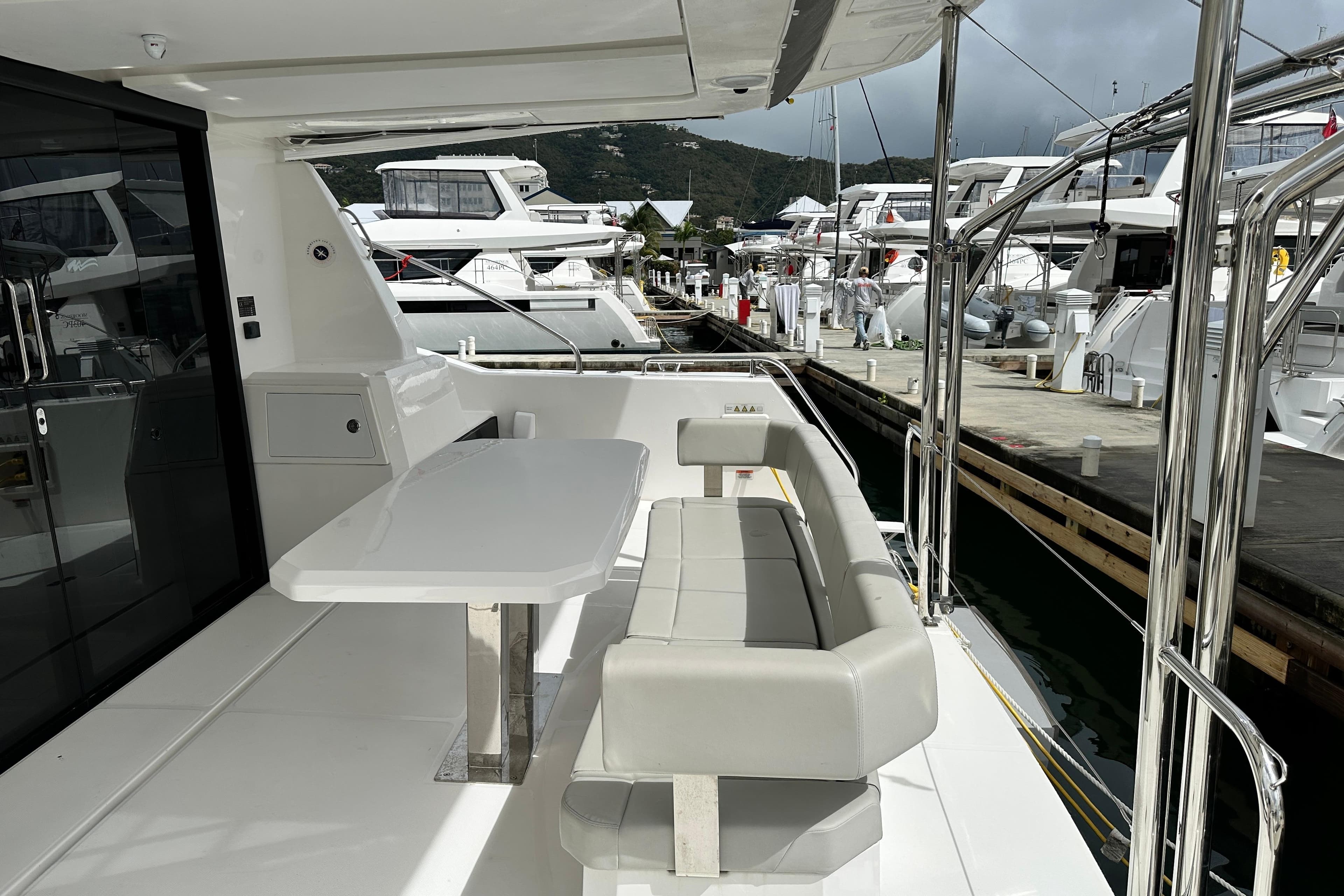 2025 Robertson and Caine Leopard 40 Powercat docked, featuring sleek outdoor seating and modern design.