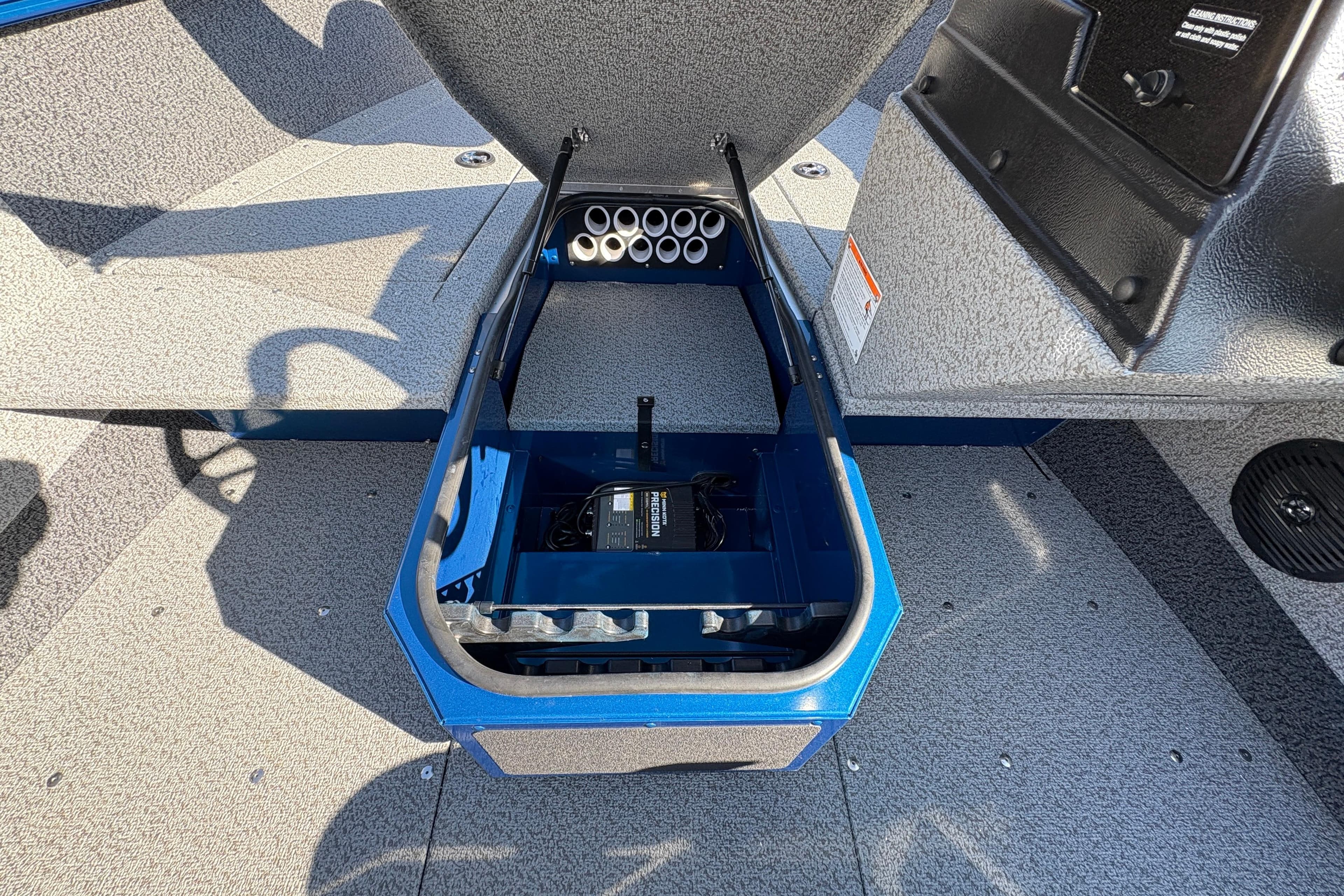 Open storage compartment in 2026 Lund 1775 Adventure SS boat interior.
